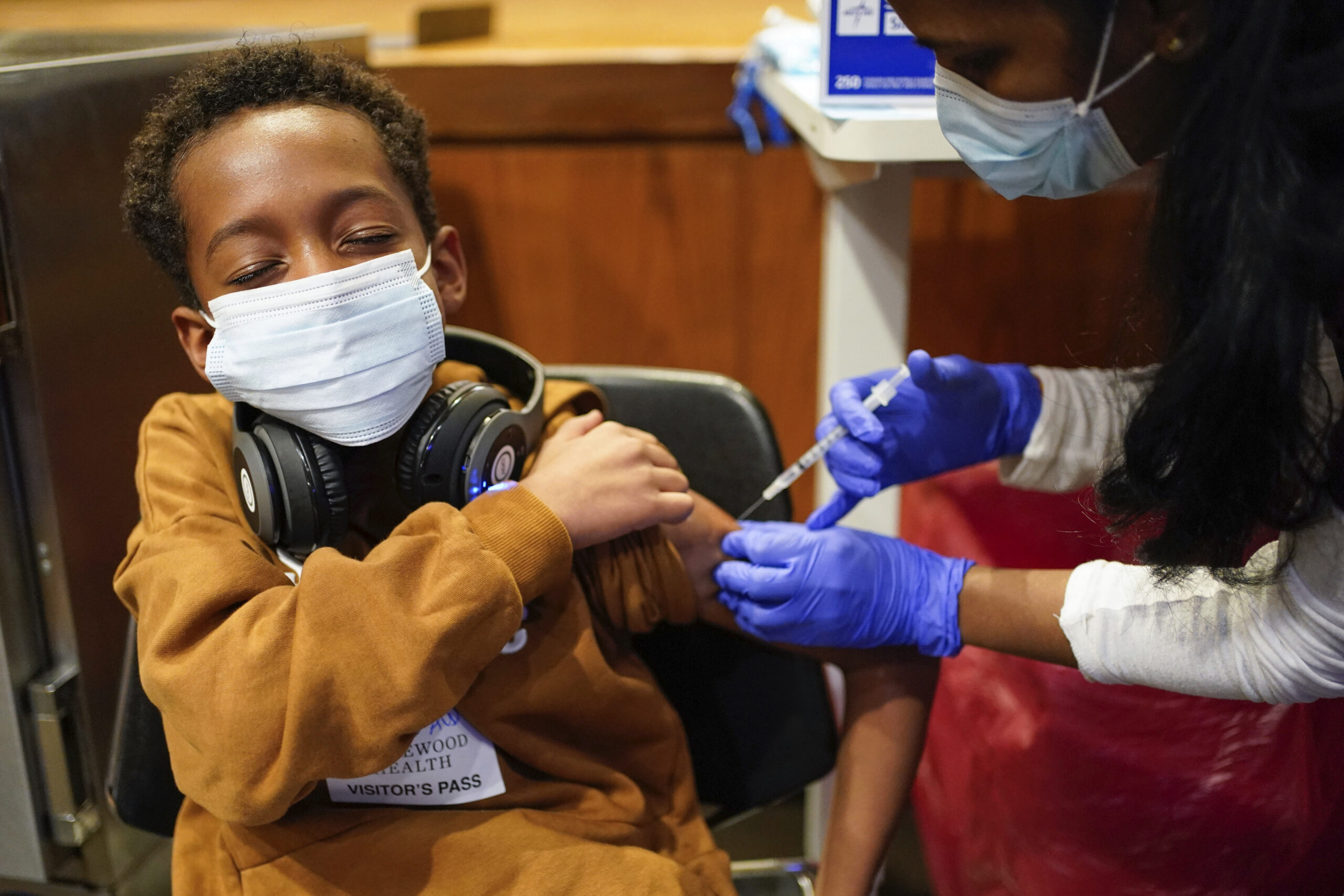 Cameron West, 9, receives a COVID-19 vaccination