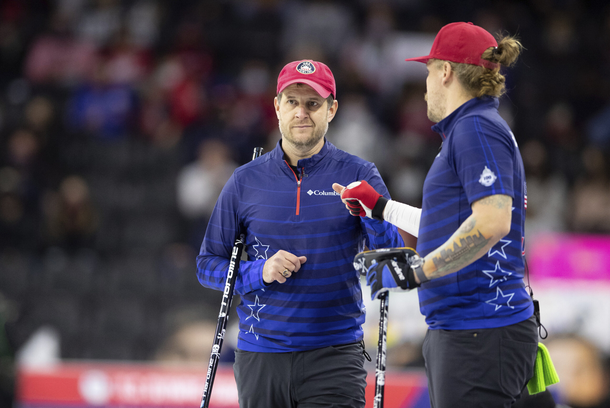 Team Shuster's John Shuster, left, fist bumps Matt Hamilton in celebration of their rock placement