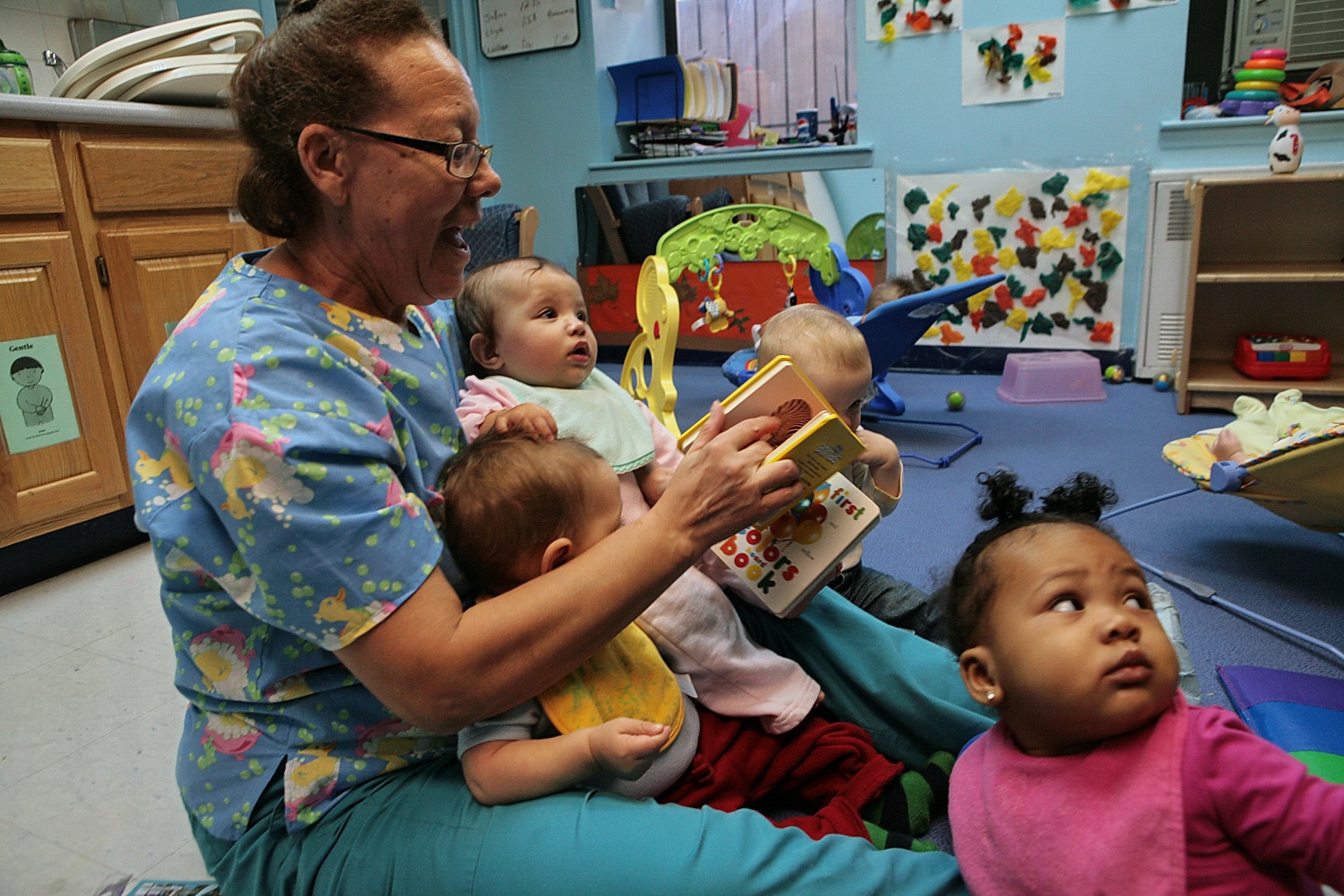 nurse reading to infants