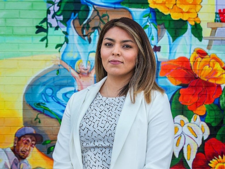 Cinthia, with the traveling statewide exhibit tour "Immigrant Journeys from South of the Border" by Wisconsin Humanities. Image by Gary Porter.