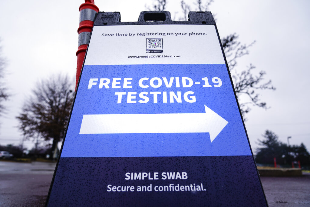 Signs direct motorist to a free drive-thru COVID-19 testing site in the parking lot of the Mercy Fitzgerald Hospital in Darby, Pa., Thursday, Jan. 20, 2022.