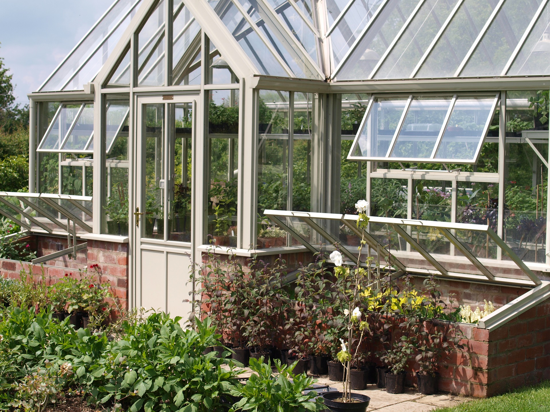 Free standing greenhouse in a garden.