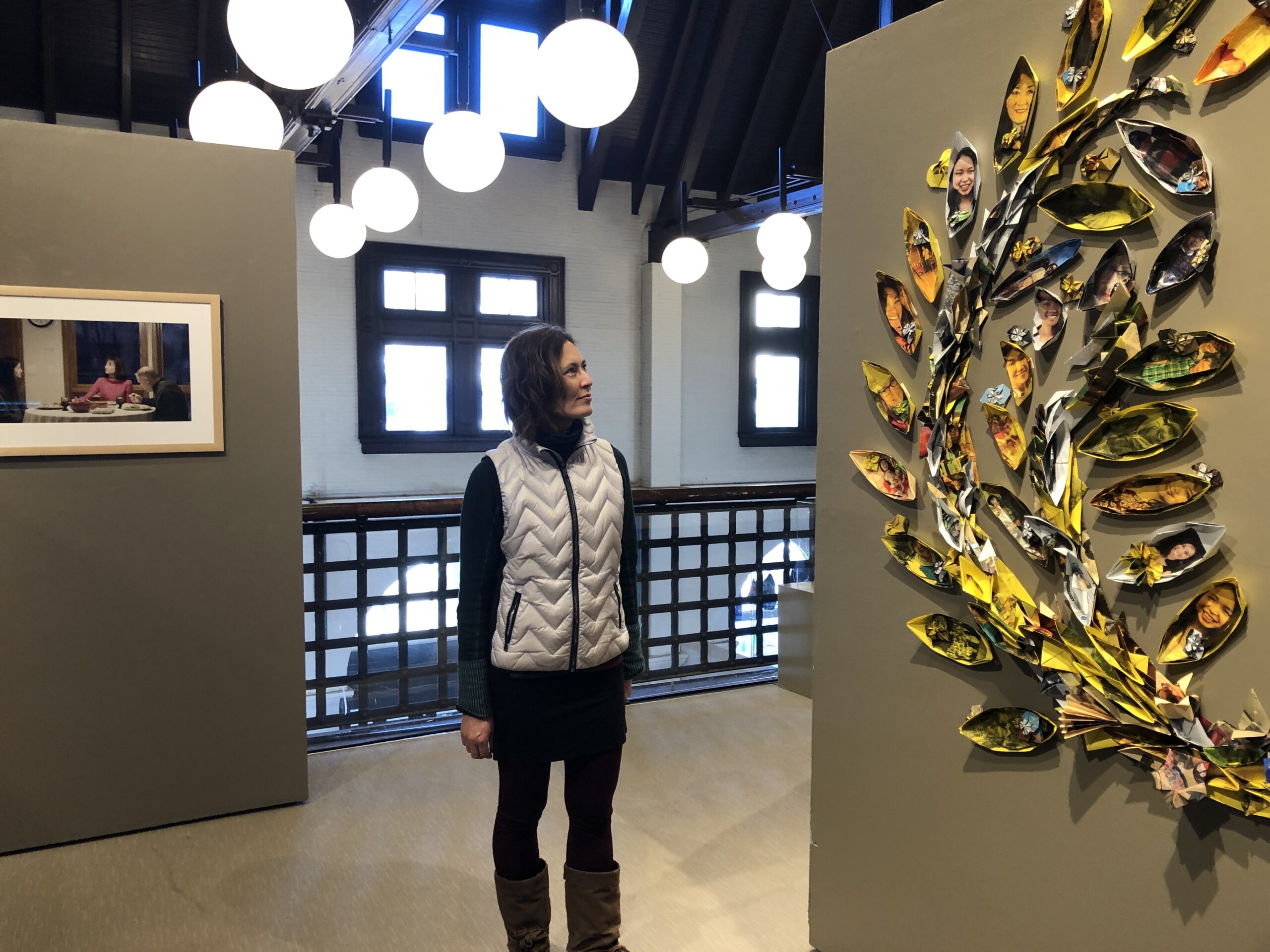 Laura Judd of the Twin Ports APIDA Collective views an origami installation in the group's "Like Me, Like You" exhibit, now showing at the Duluth Art Institute. WPR/ Robin Washington.