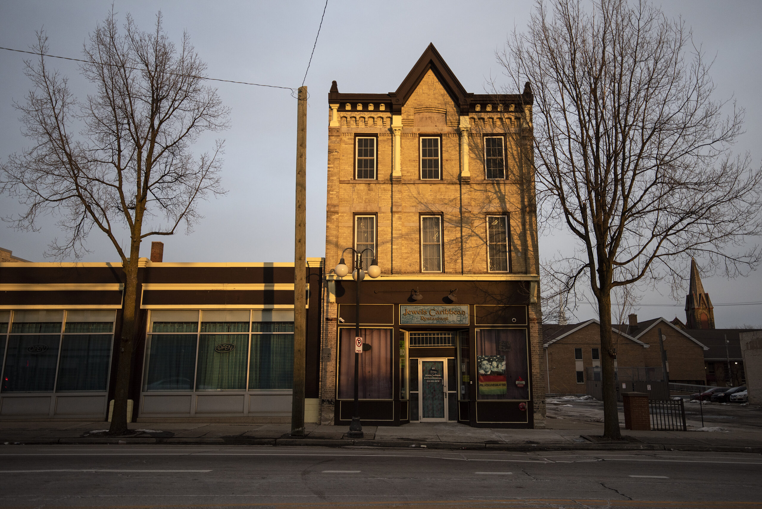 The sun shines on a building in a Milwaukee neighborhood.