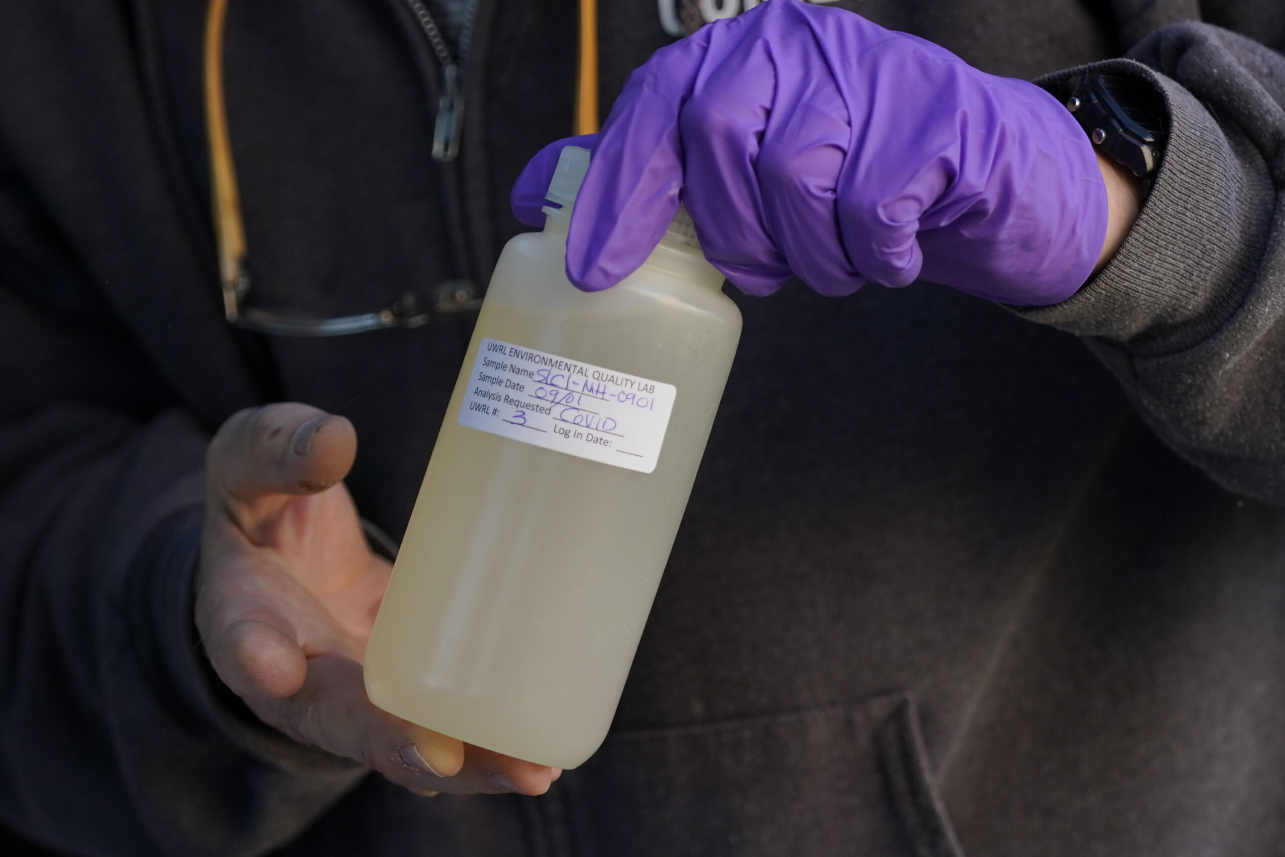 Utah State professor Ryan Dupont collects sewage samples from the dorms
