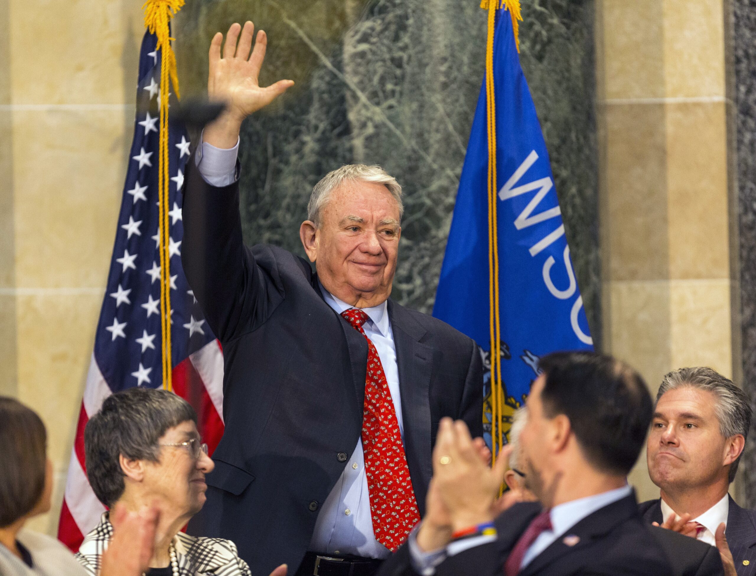 Former Wisconsin Gov. Tommy Thompson waves to the crowd