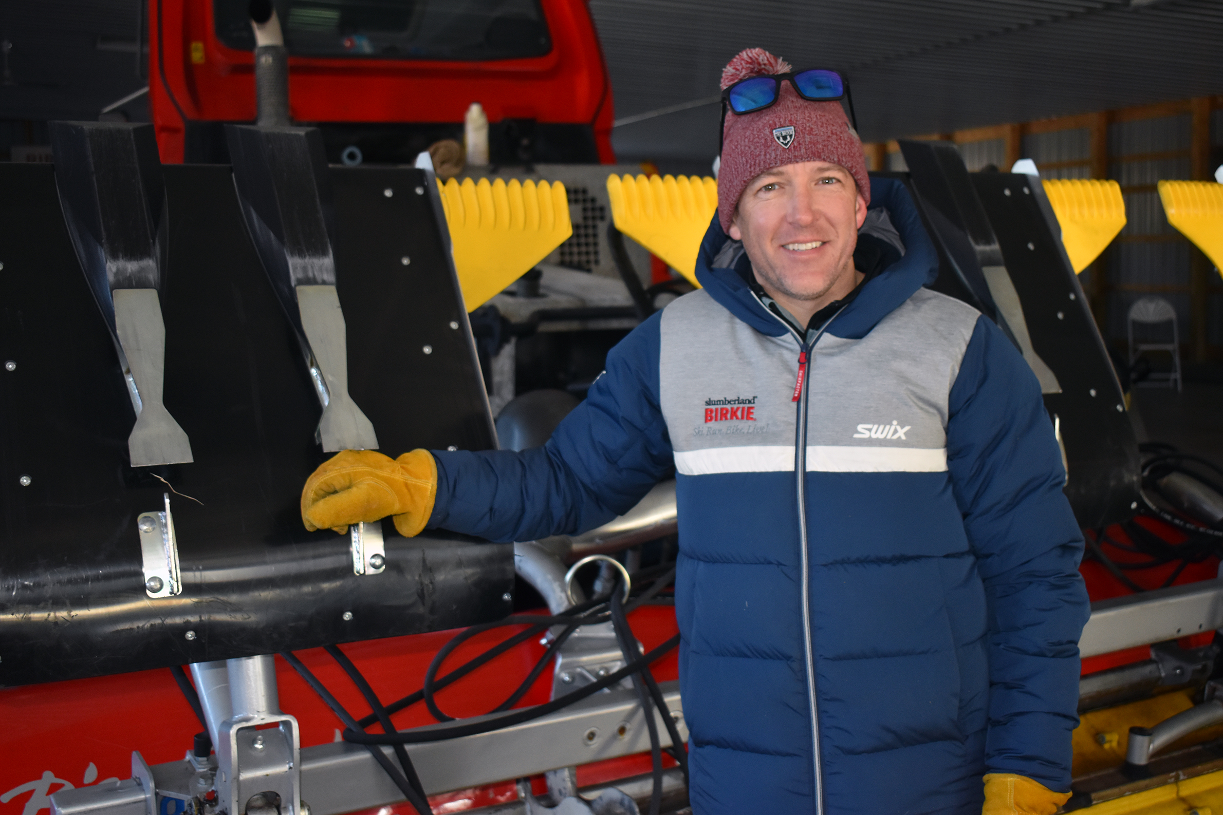 Ben Popp next to snow grooming machine