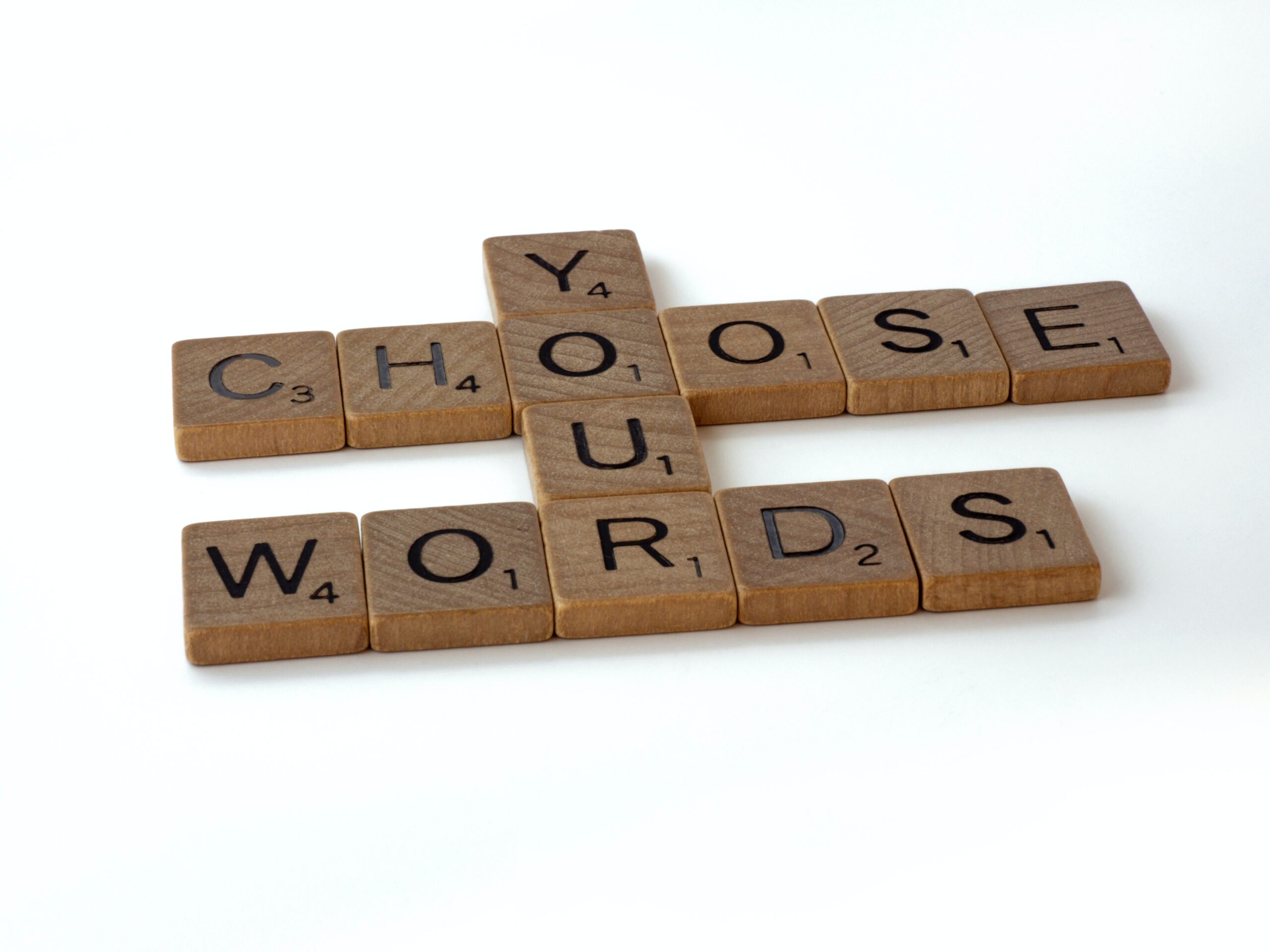 Scrabble letters spelling out "Choose Your Words"
