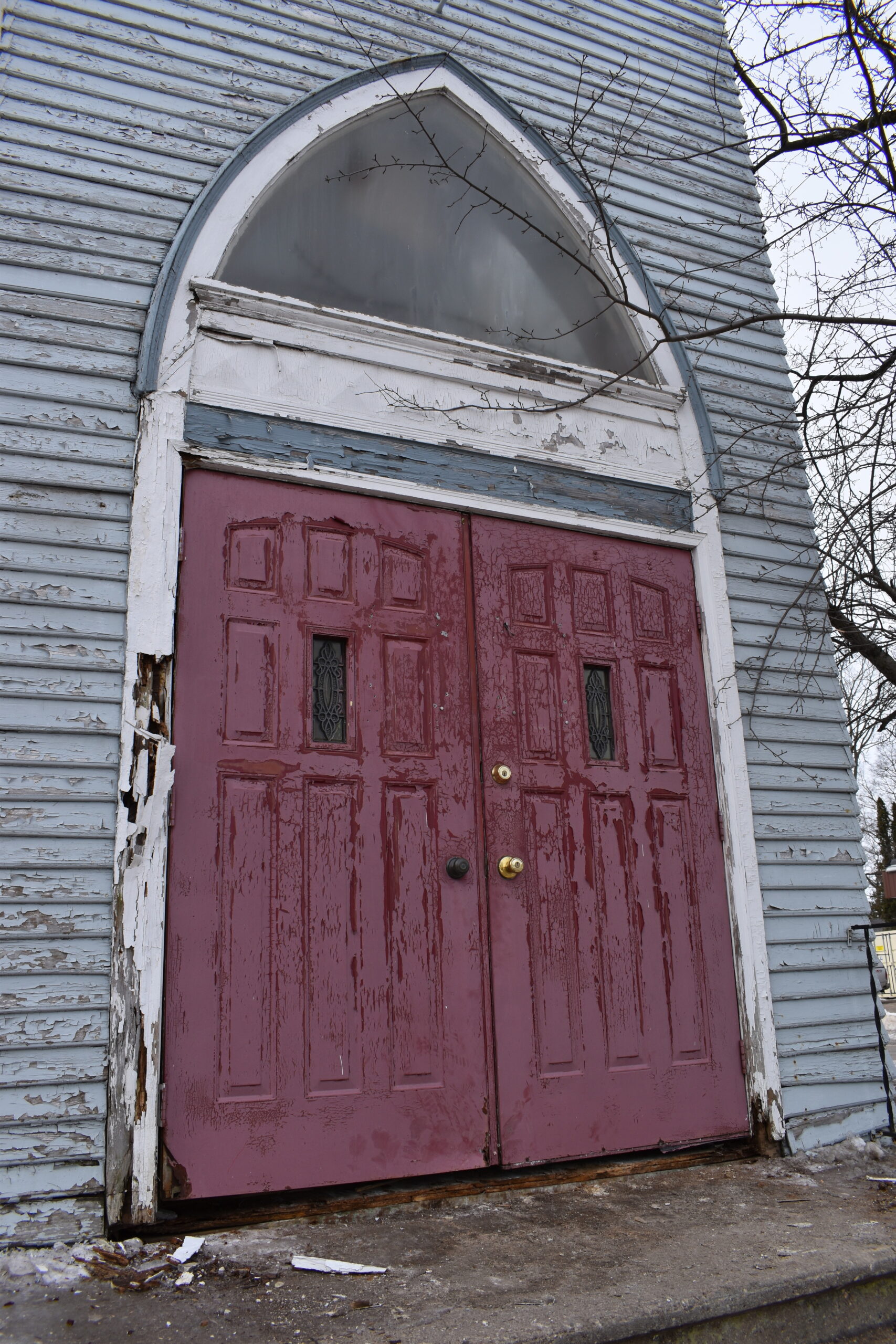 The front doors of the 120-year-old Trinity Lutheran Church building in Stevens Point show signs of age. 