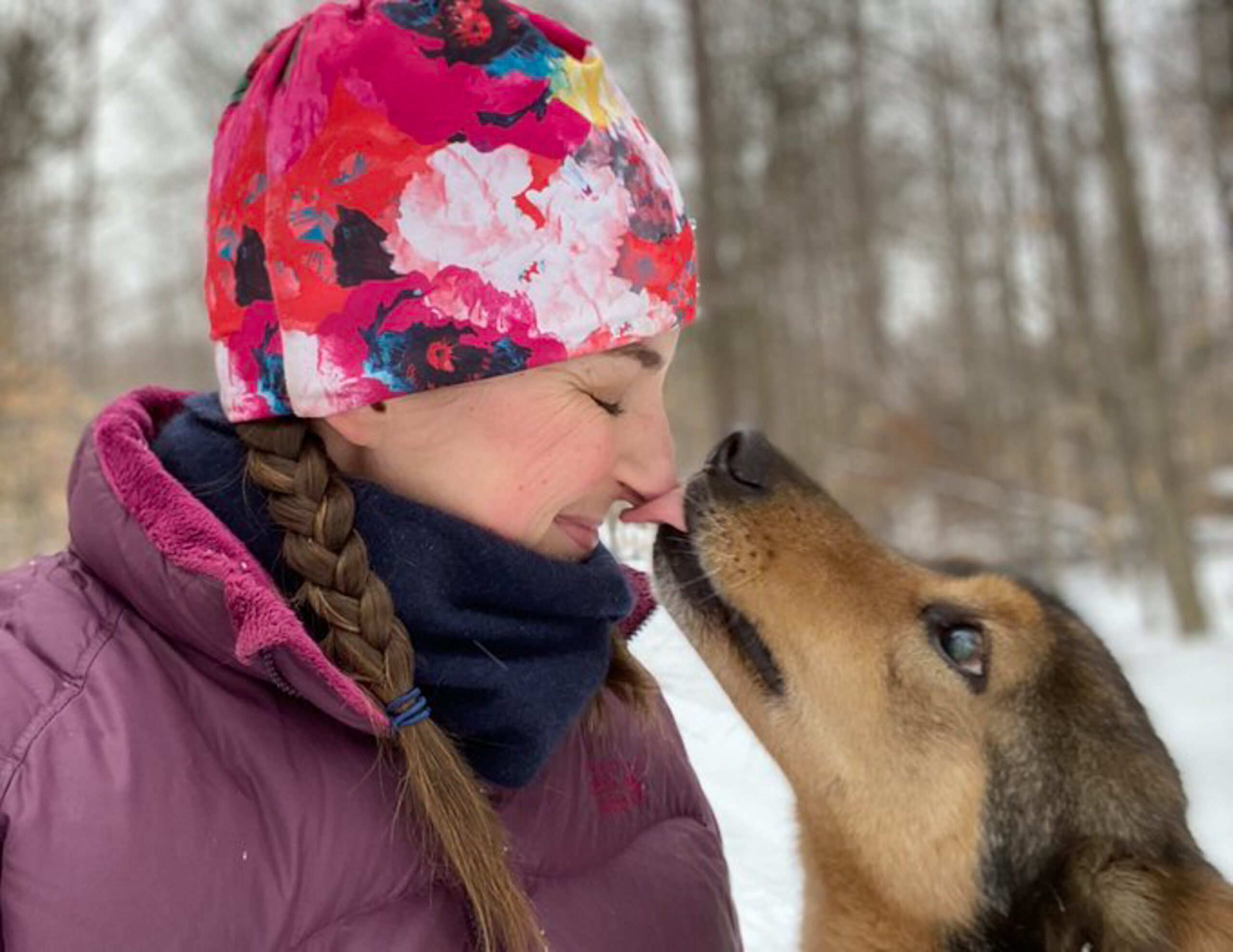 Wisconsin musher Blair Braverman with one of the dogs on the trail