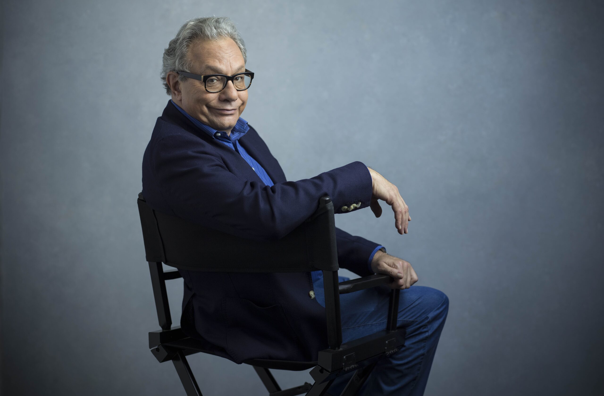 Lewis Black sitting in director's chair