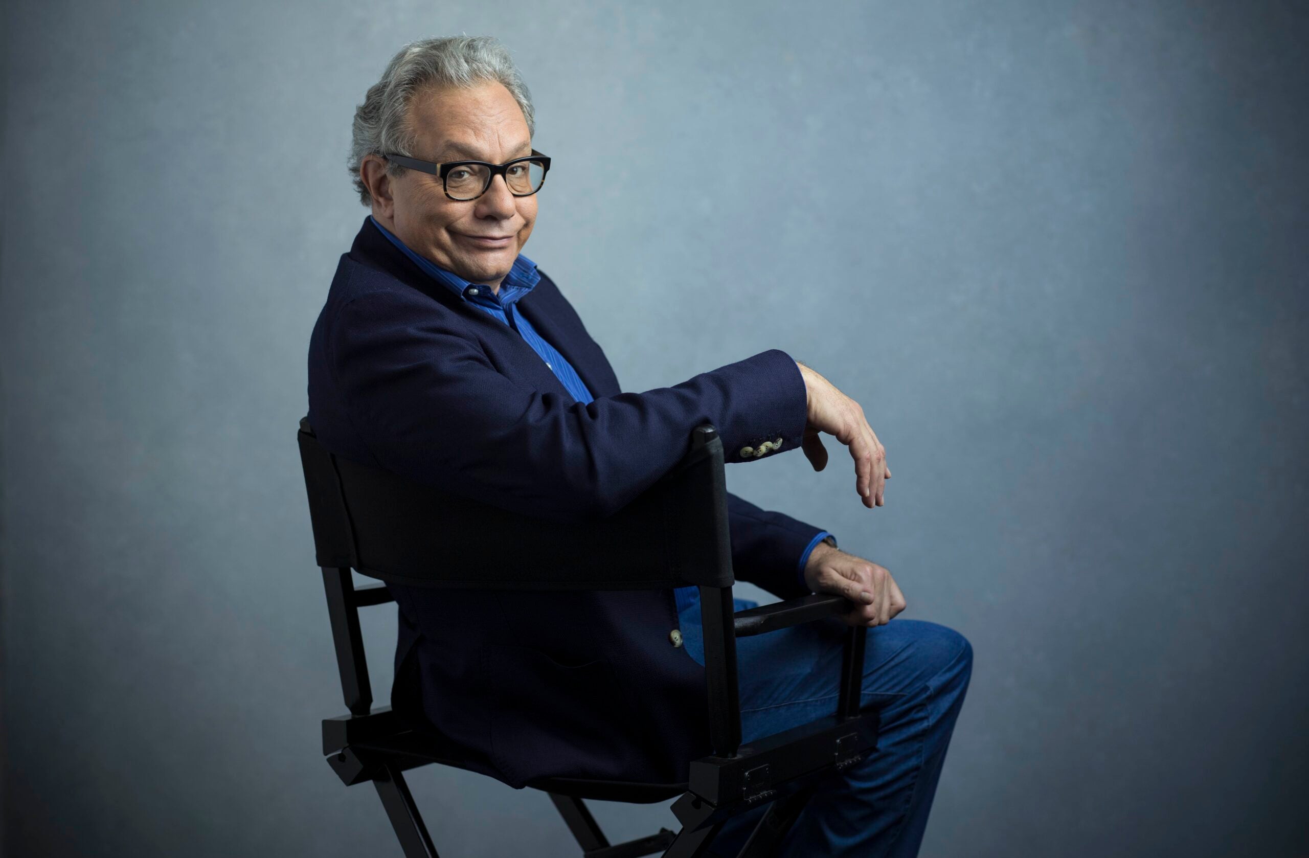 Lewis Black sitting in director's chair