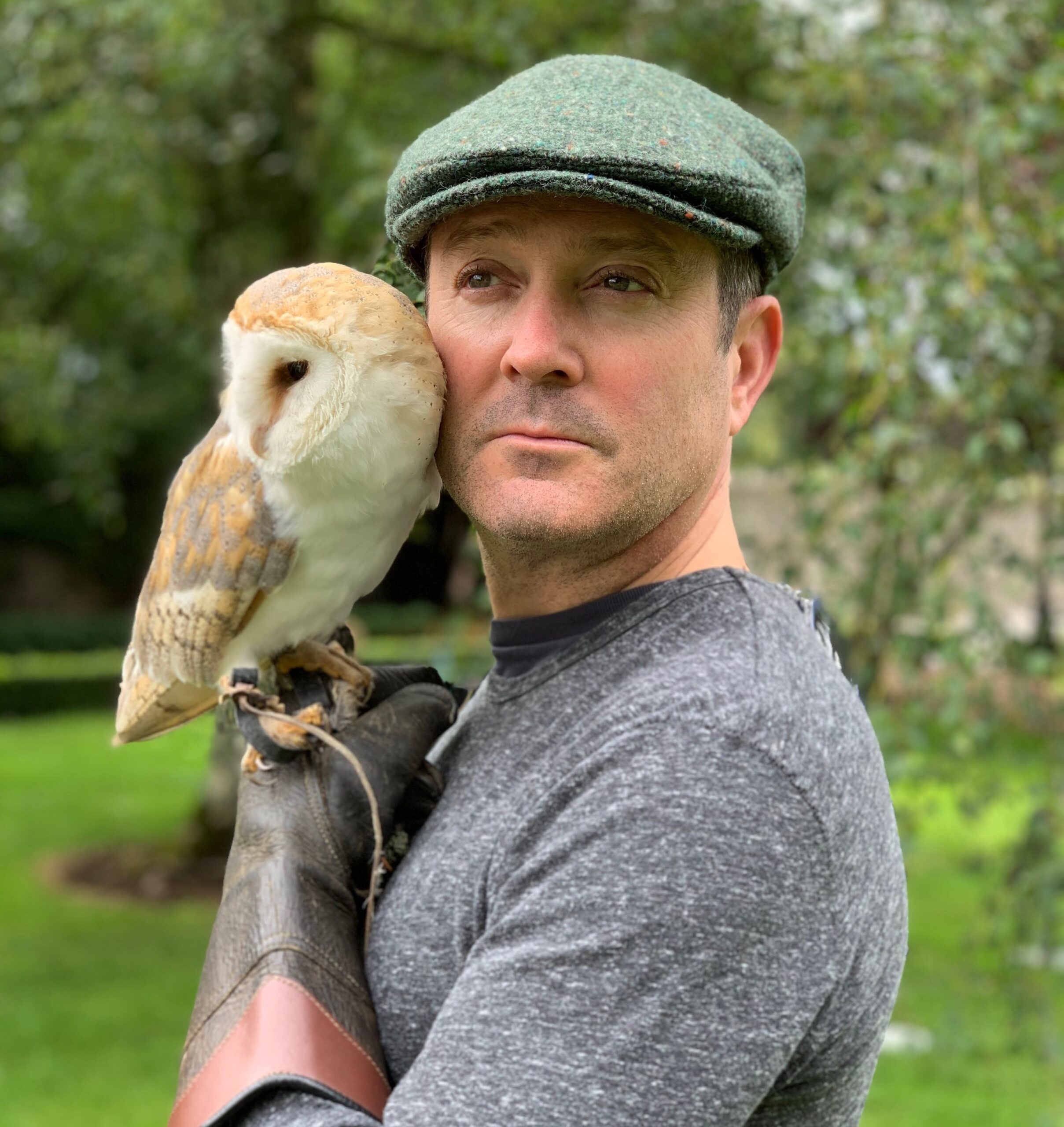 Thomas Lennon holding owl to face
