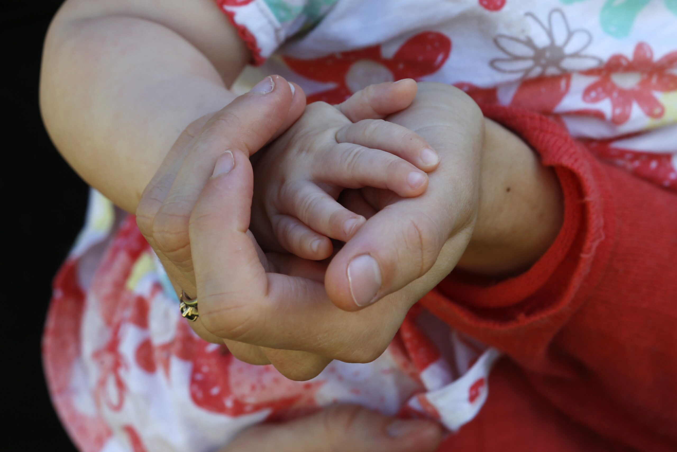 Sara Adelman holds her daughter Amelia's hand