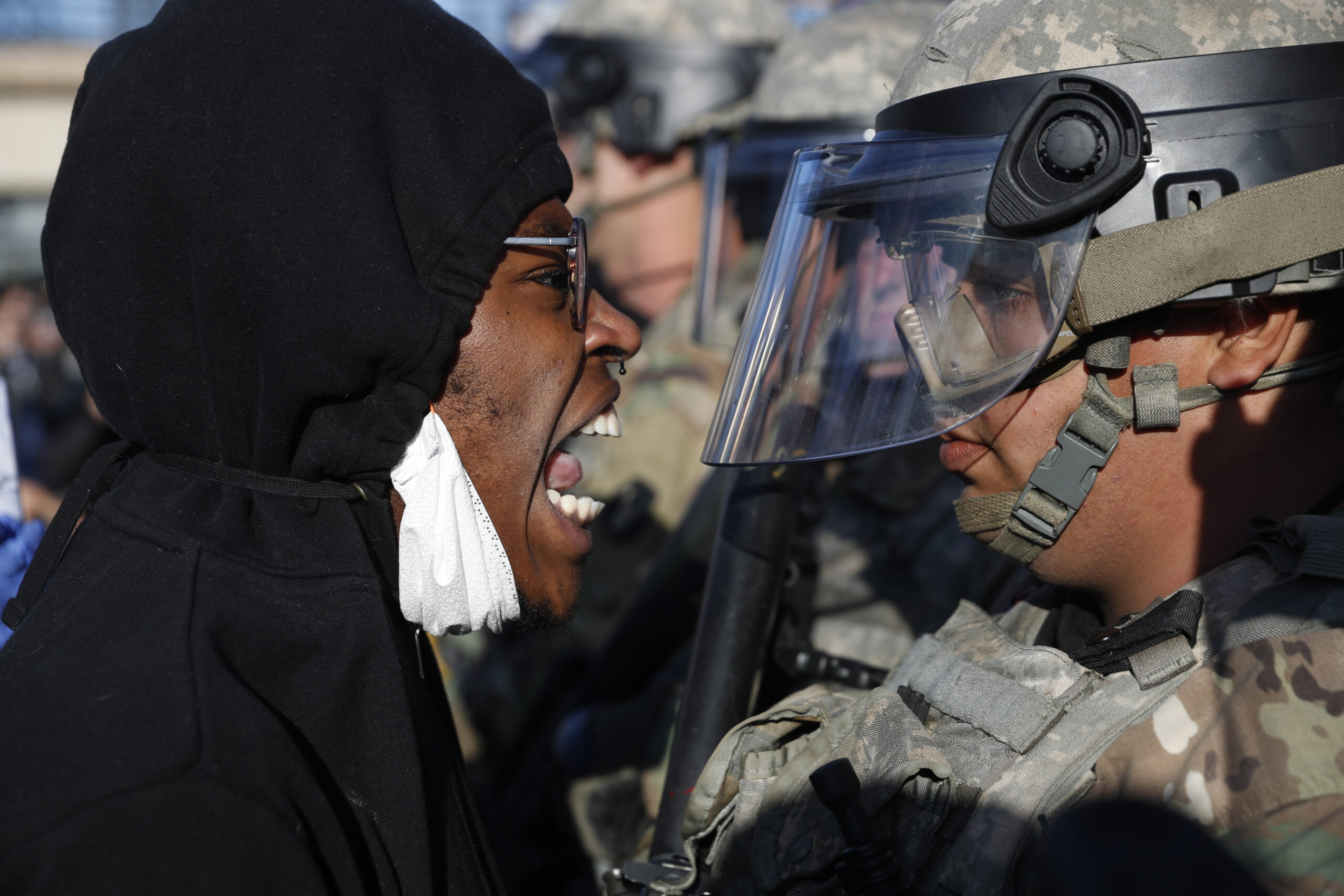 A protester yells at a member of the Minnesota National Guard in Minneapolis