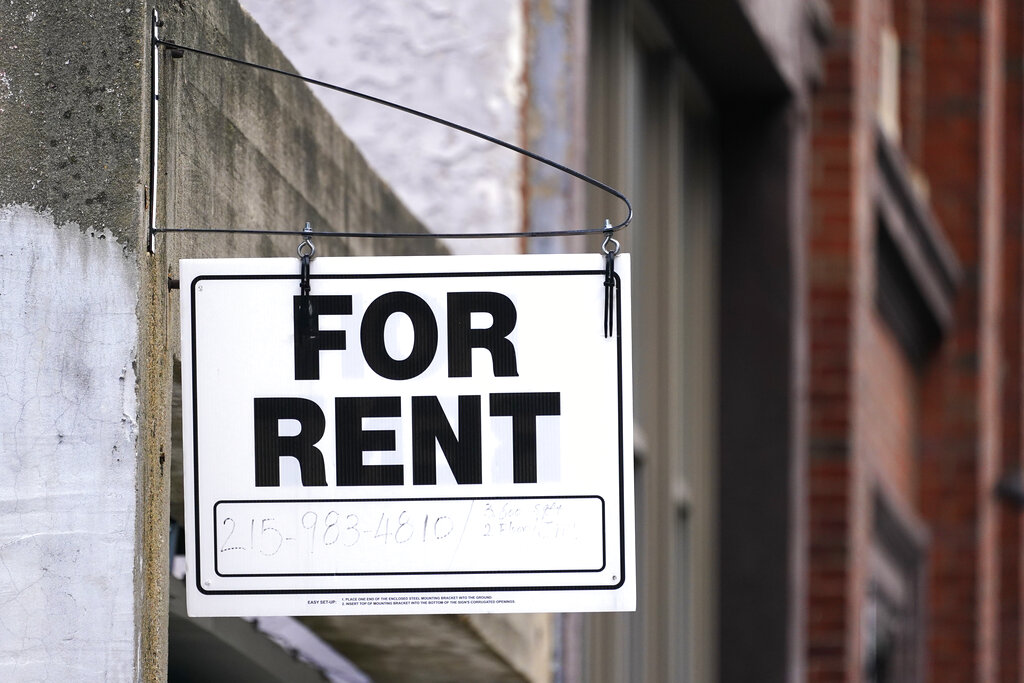 A for rent sign is posted on a building