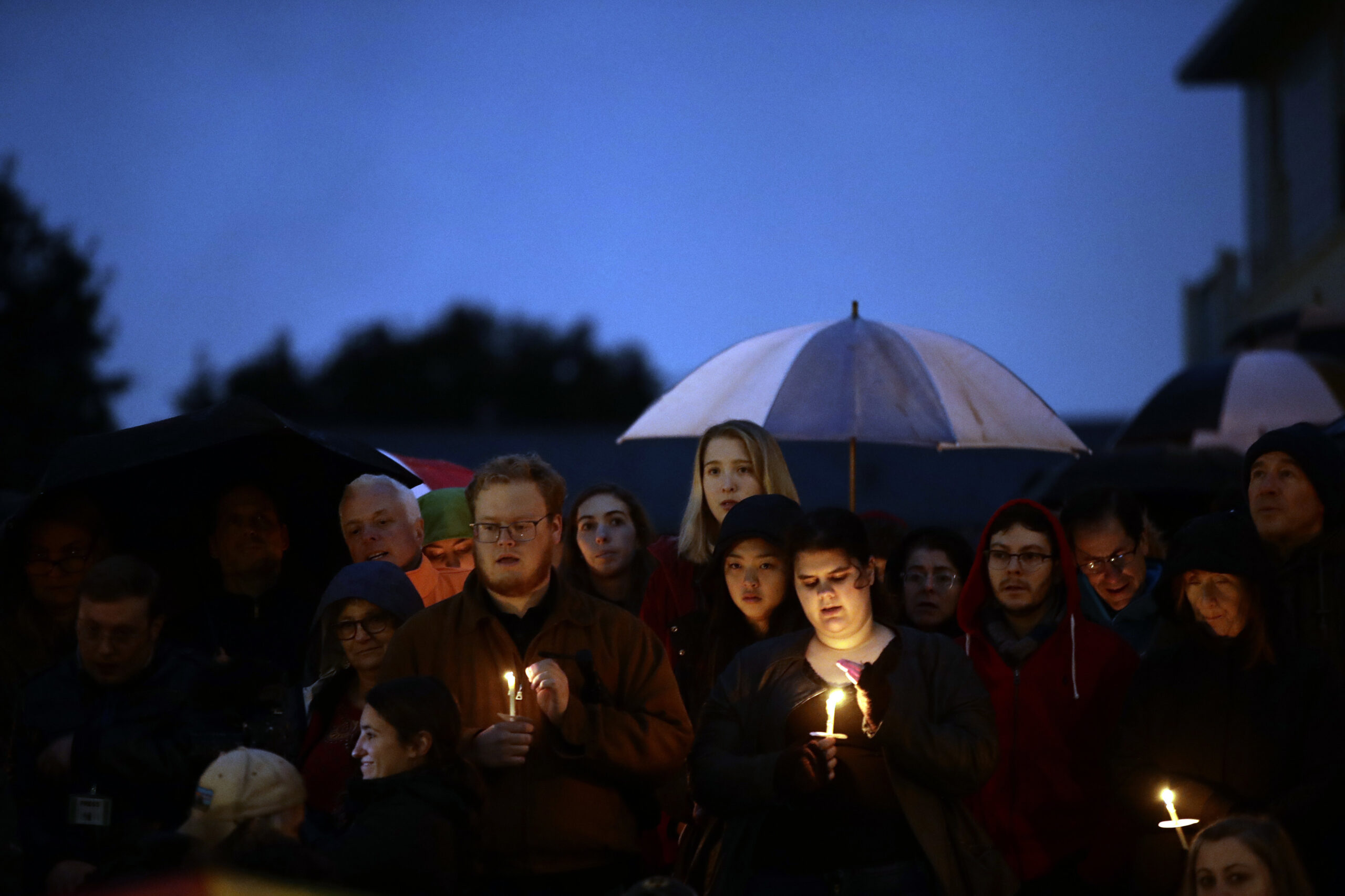 People hold candles as they gather for a vigil in the aftermath of a deadly shooting at the Tree of Life Congregation