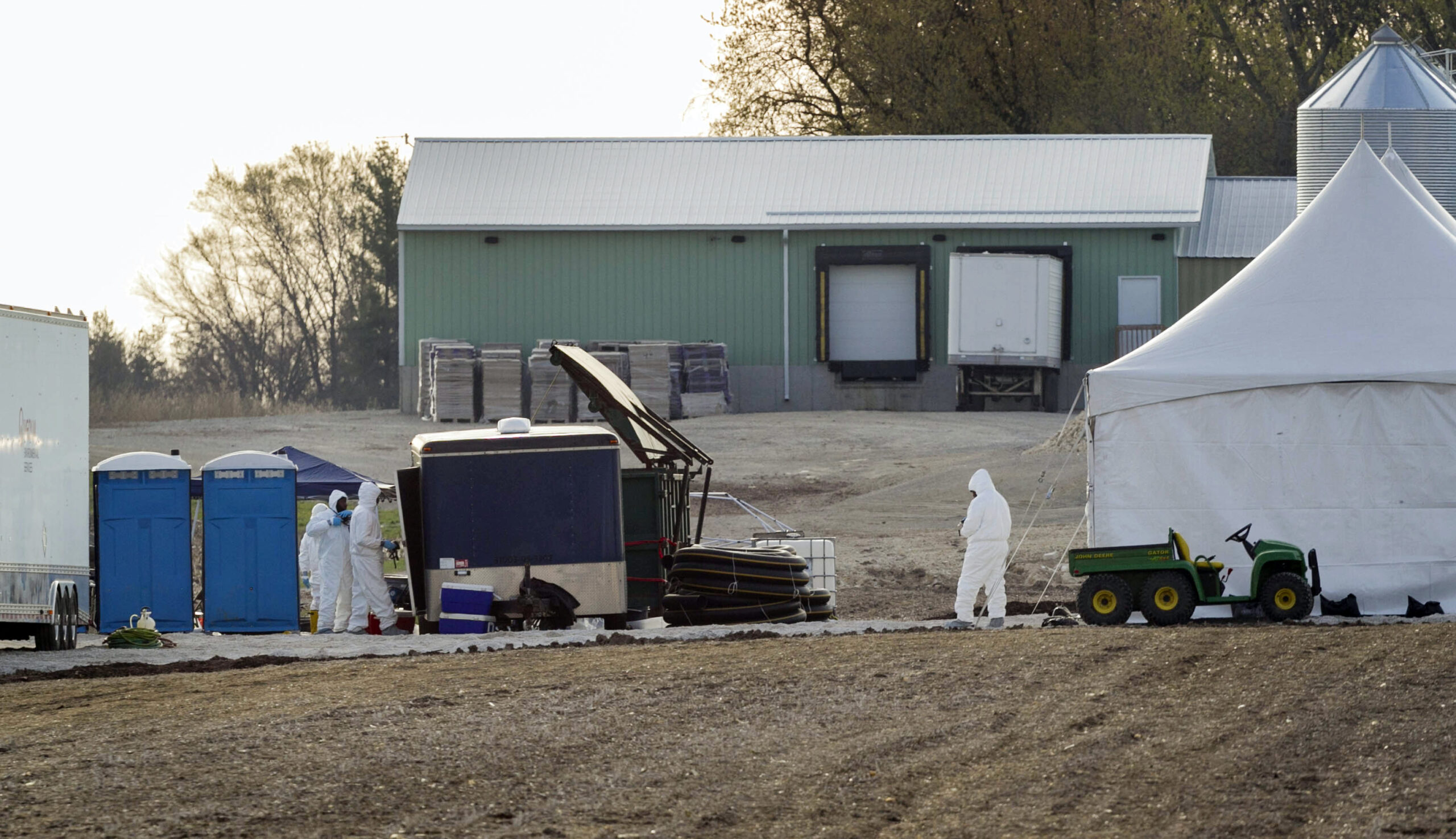 Workers in protective clothing work at a hen farm in Jefferson County in 2015 where an outbreak of avian flu had occurred.