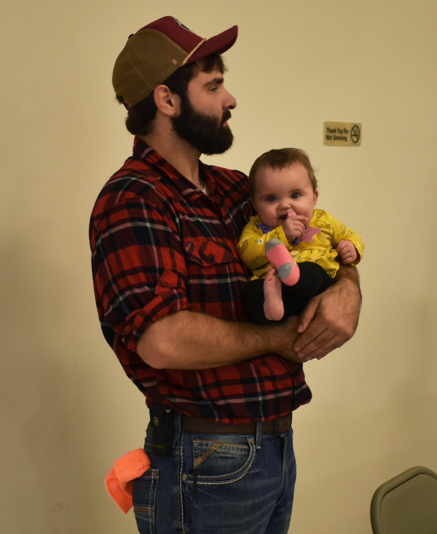 Justin Bloch holds his daughter, Jennifer, at a community benefit for the family in Merrill