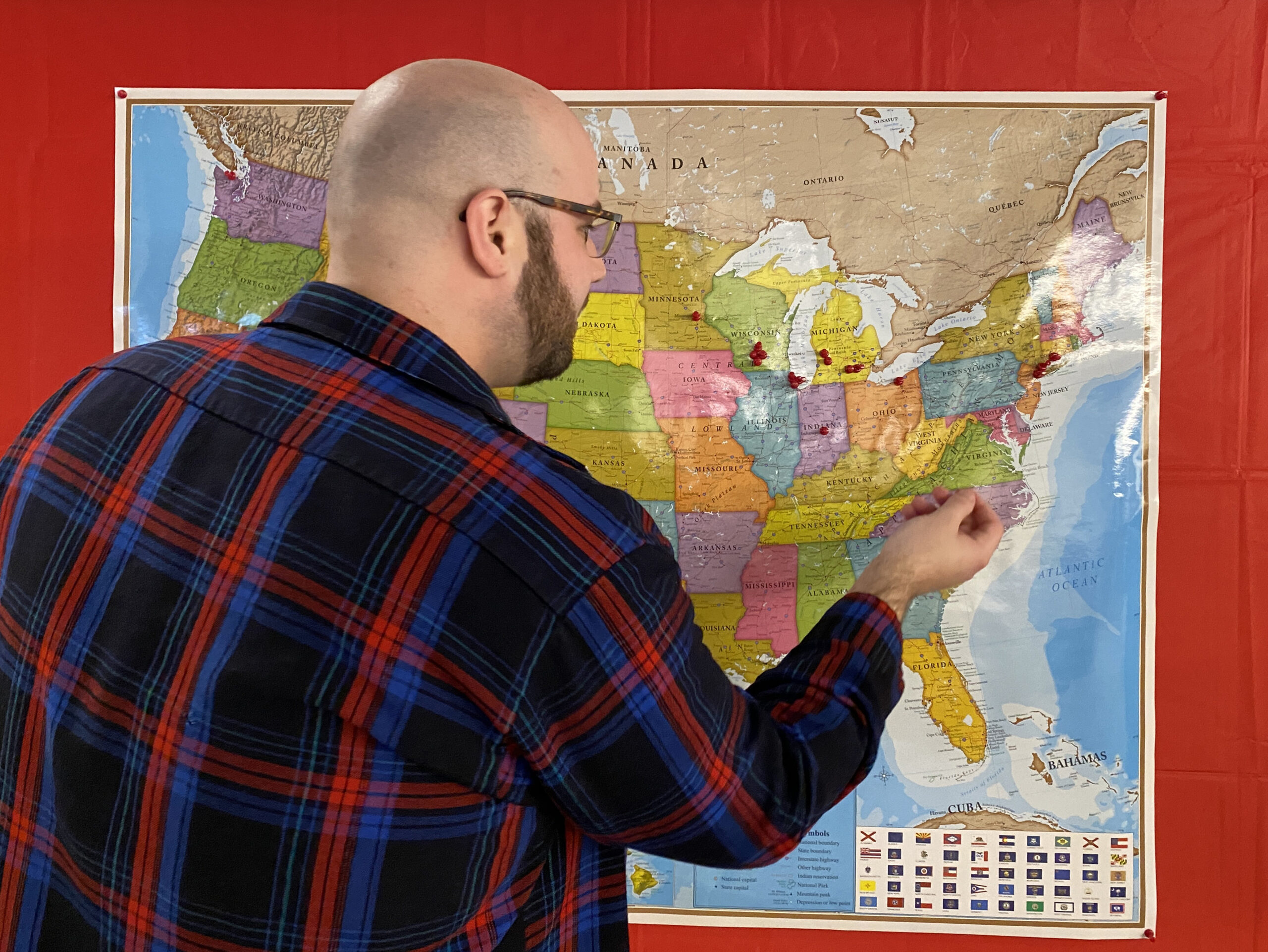 Trevor Cooper, UW School of Medicine Class of 2022, adds a pushpin to the bulletin board to indicate where he will be completing his residency — OB-GYN at Mountain Area Health Education Center in Asheville, N.C.