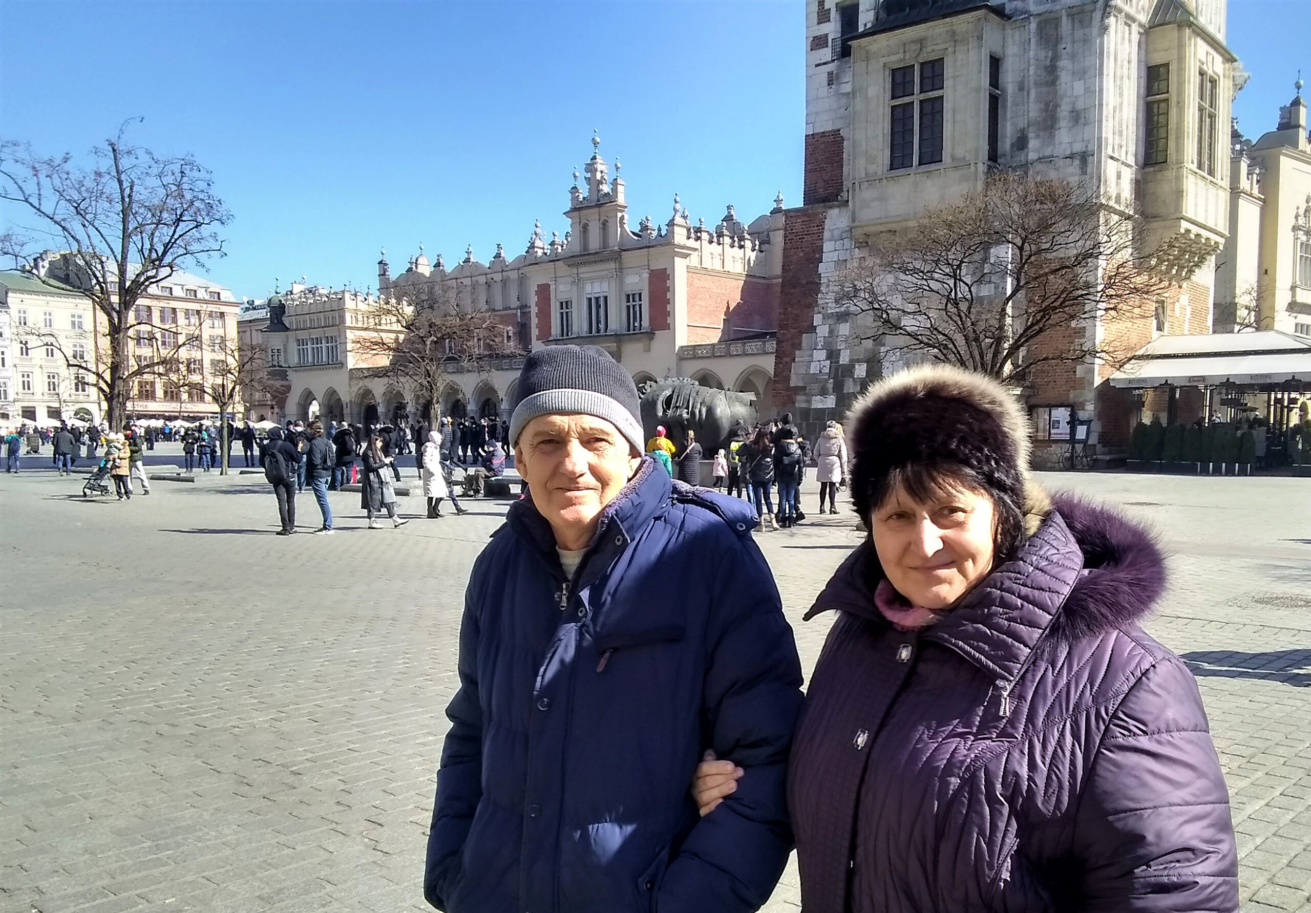 Tanya and Slava stand in front of a large outdoor plaza.