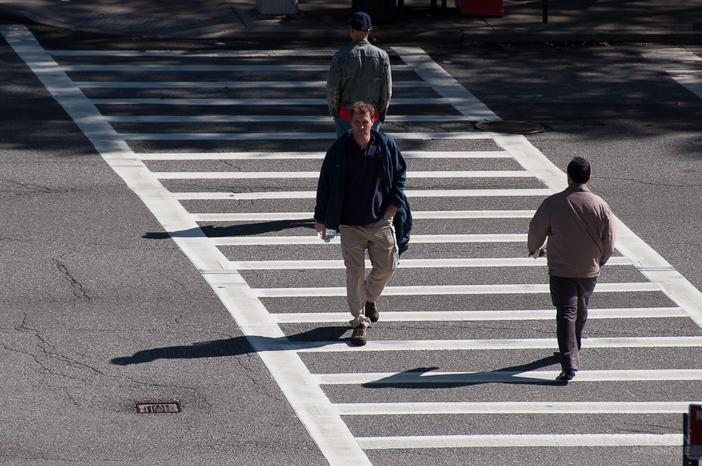 Man crossing street in crosswalk