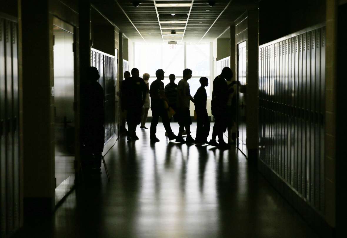 Students walk through the halls in a high school.