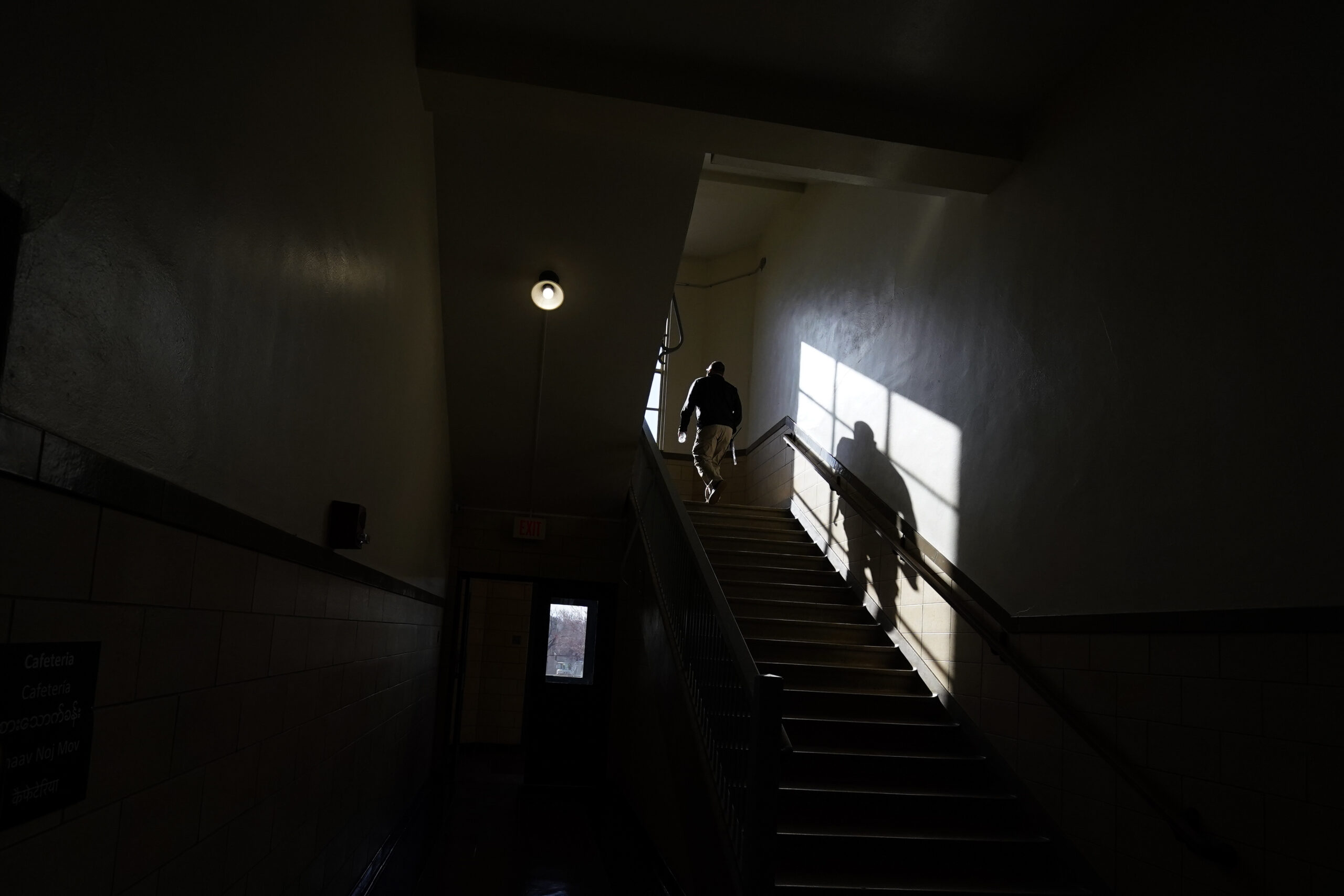 A staff member walks up a staircase on the first day of in-person learning