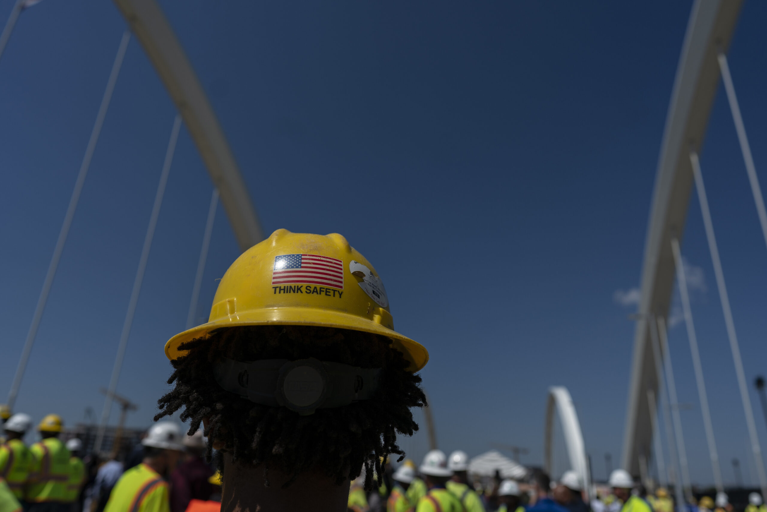 A worker wears a "think safety" hardhat 