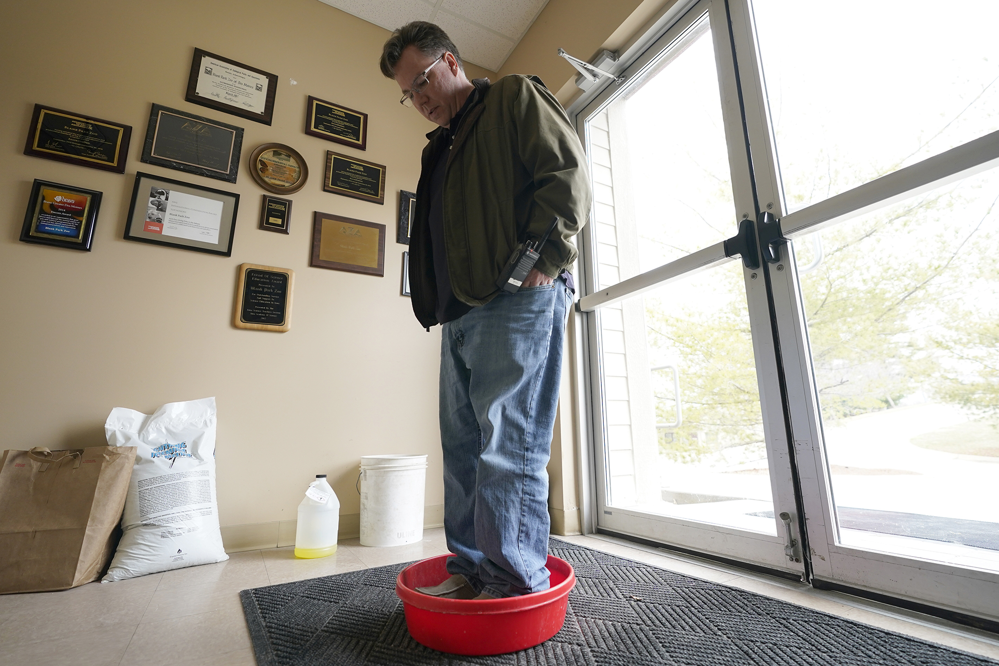 Chief Marketing Officer Ryan Bickel walks through a shoe disinfectant