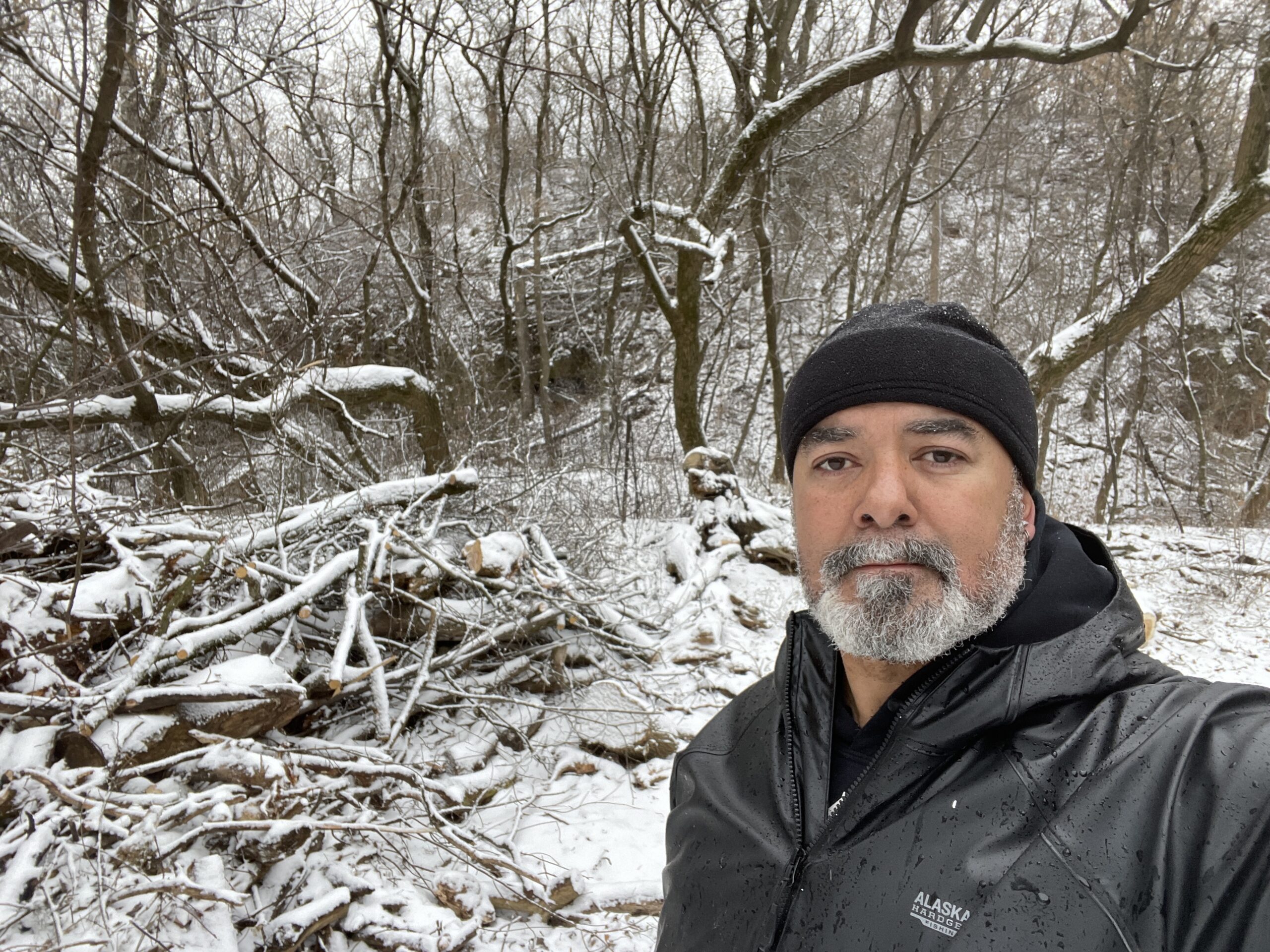 Christopher Kilgour takes a selfie in front of snowy woods