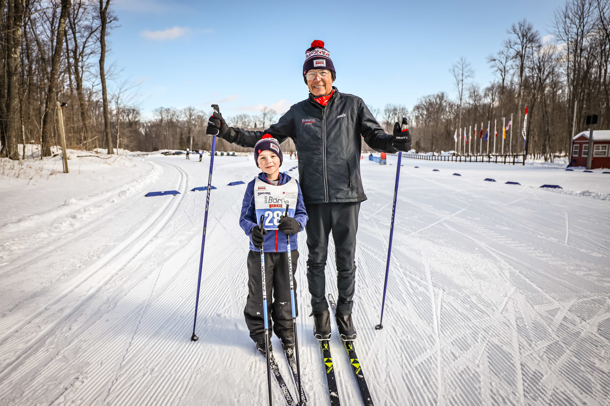 Ernie St. German stands next to his grandson Benjamin as the two are on skis