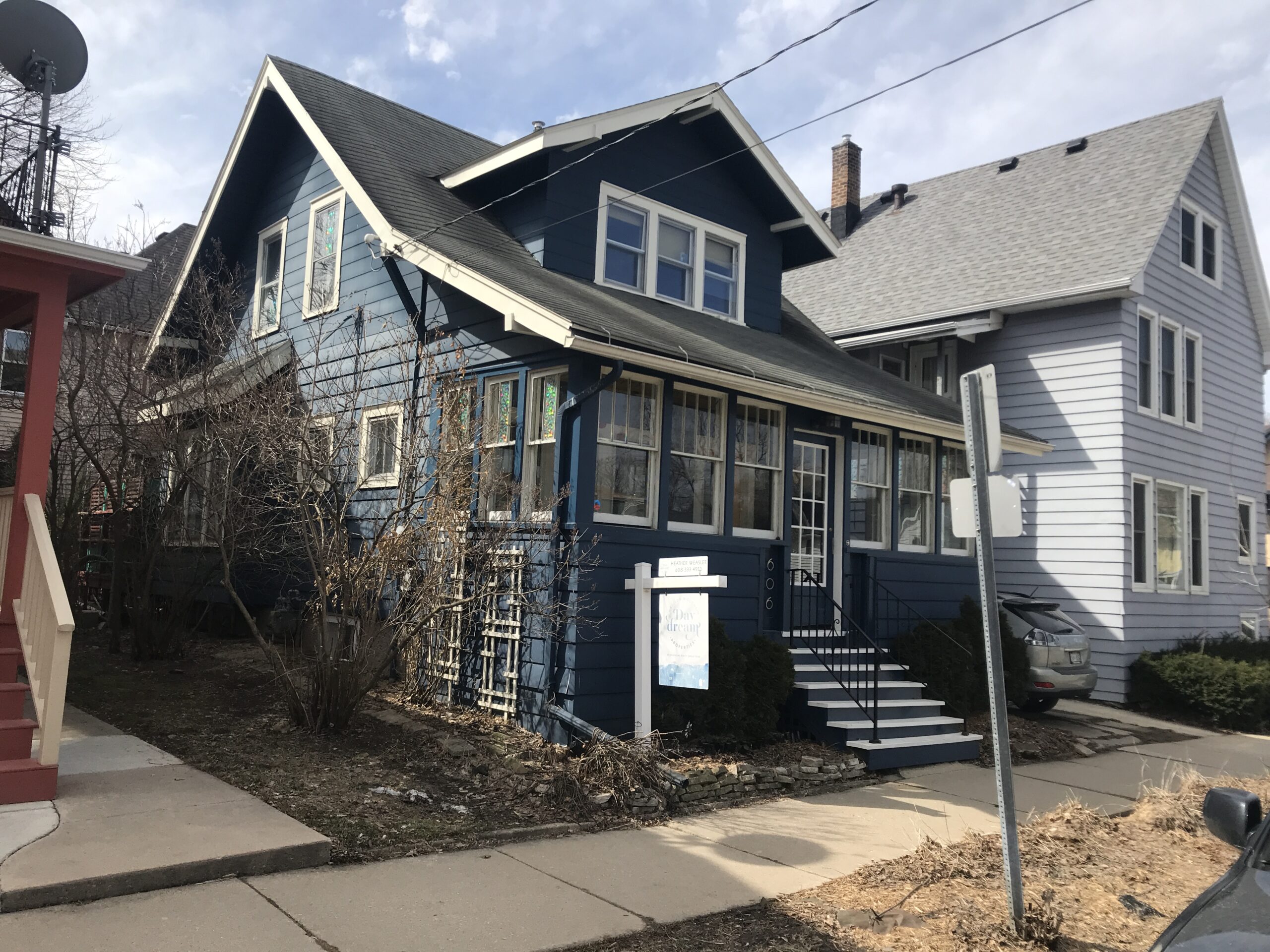 A house with a for sale in front