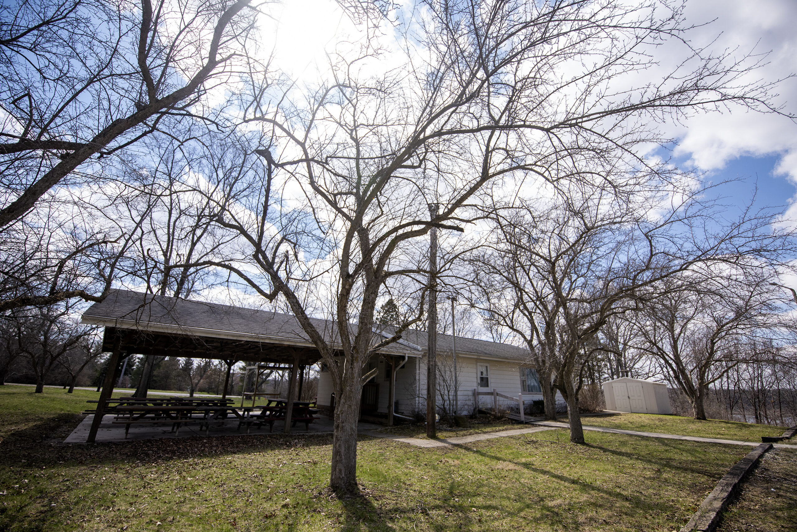 Trees rise above a small clubhouse.