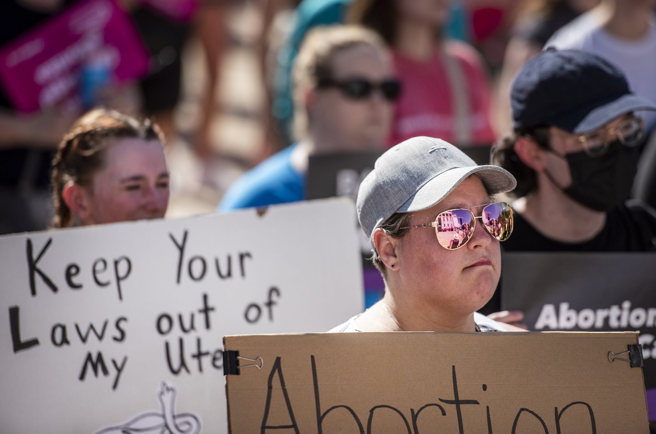 The Wisconsin state Capitol is reflected in a protester's glasses.