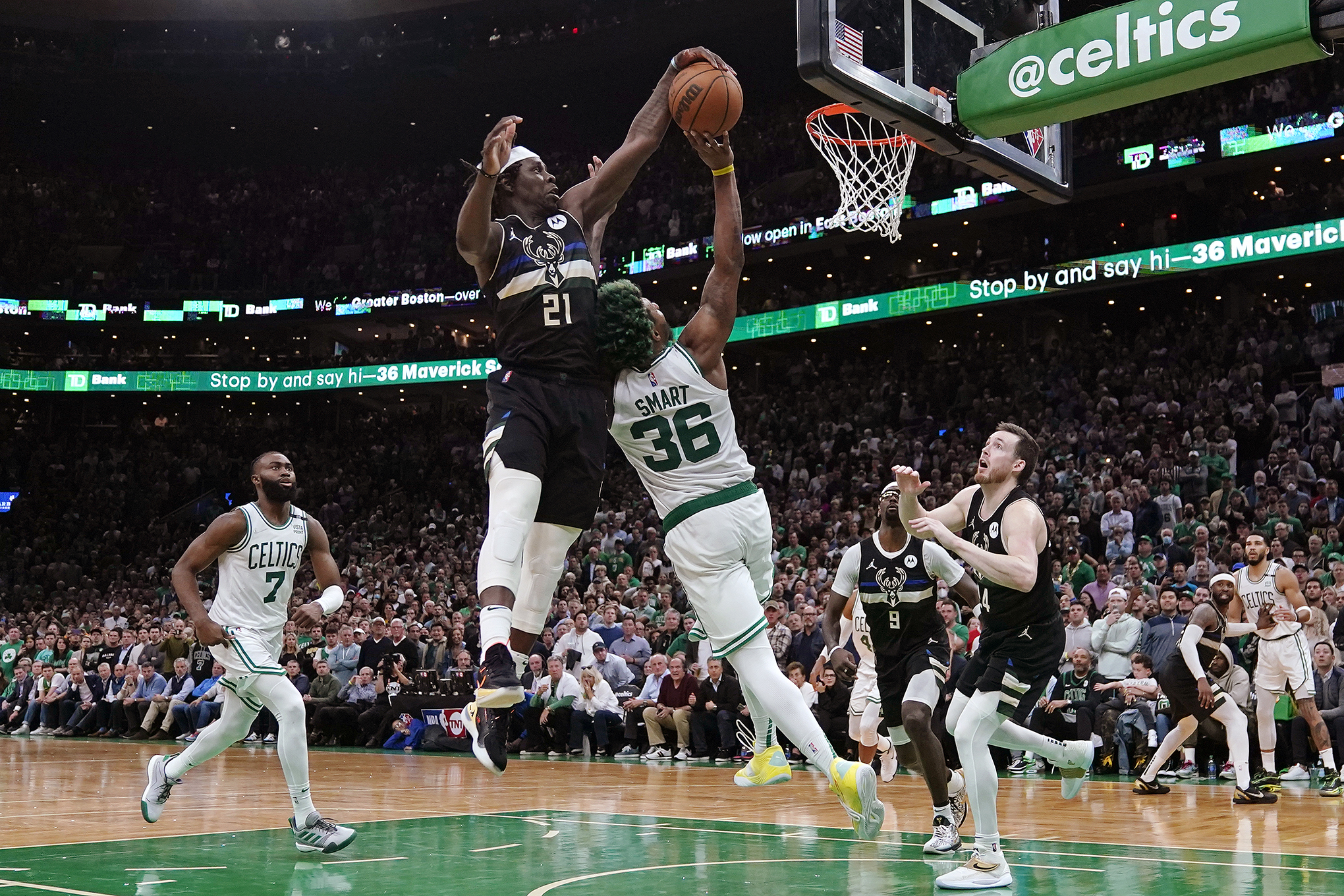 Bucks guard Jrue Holiday blocks a shot by Celtics guard Marcus Smart