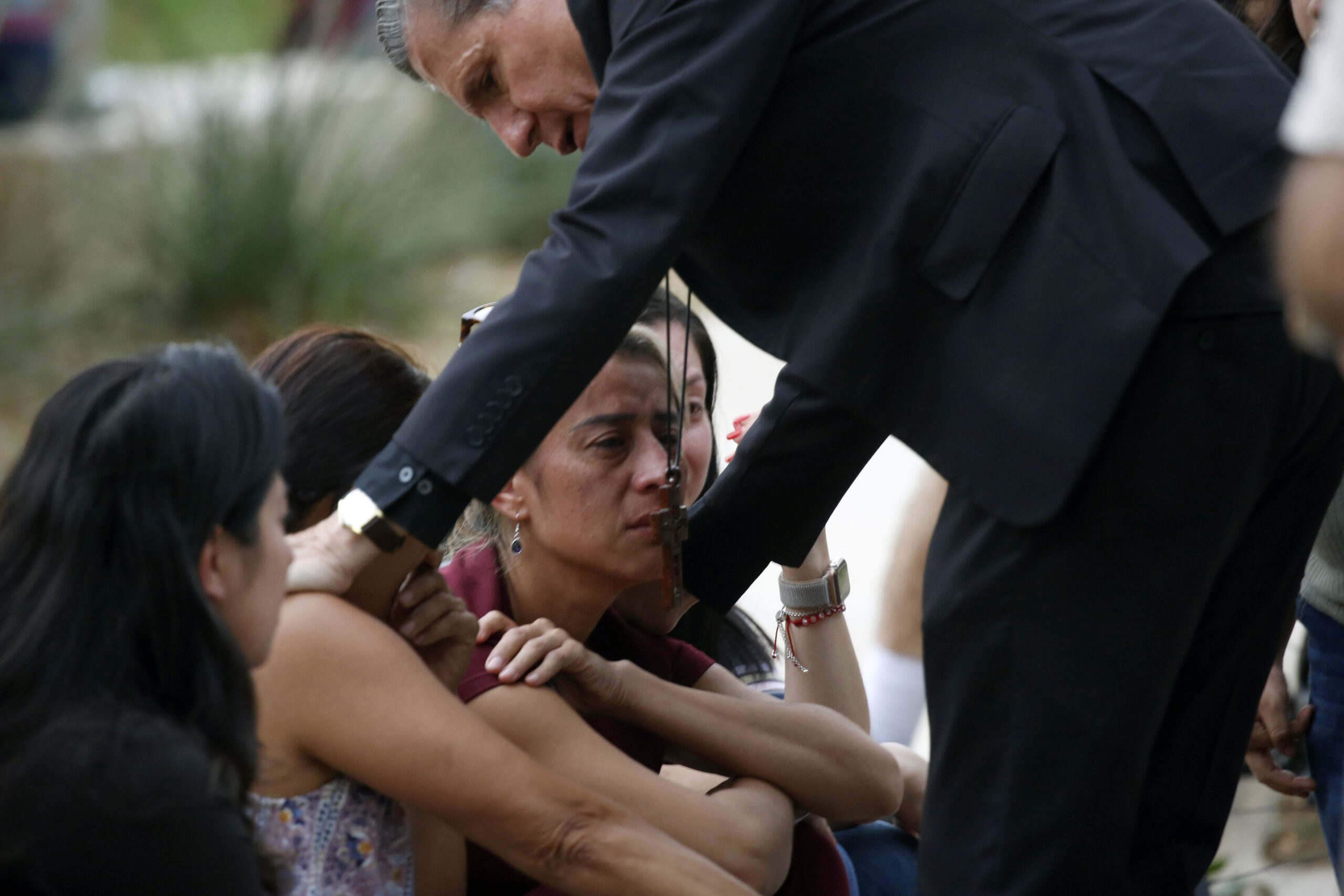The archbishop of San Antonio comforts families following a deadly school shooting at Robb Elementary School