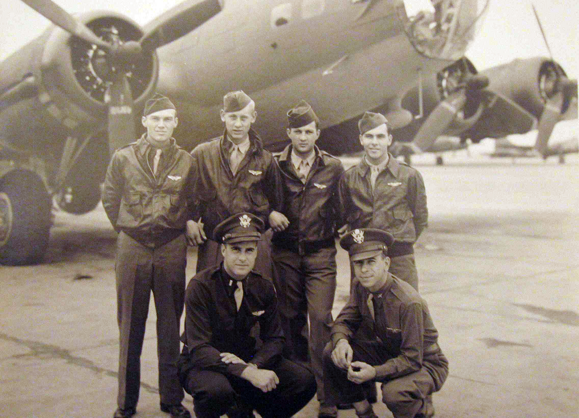 Six men who are a crew for a World War II bomber pose for a photo