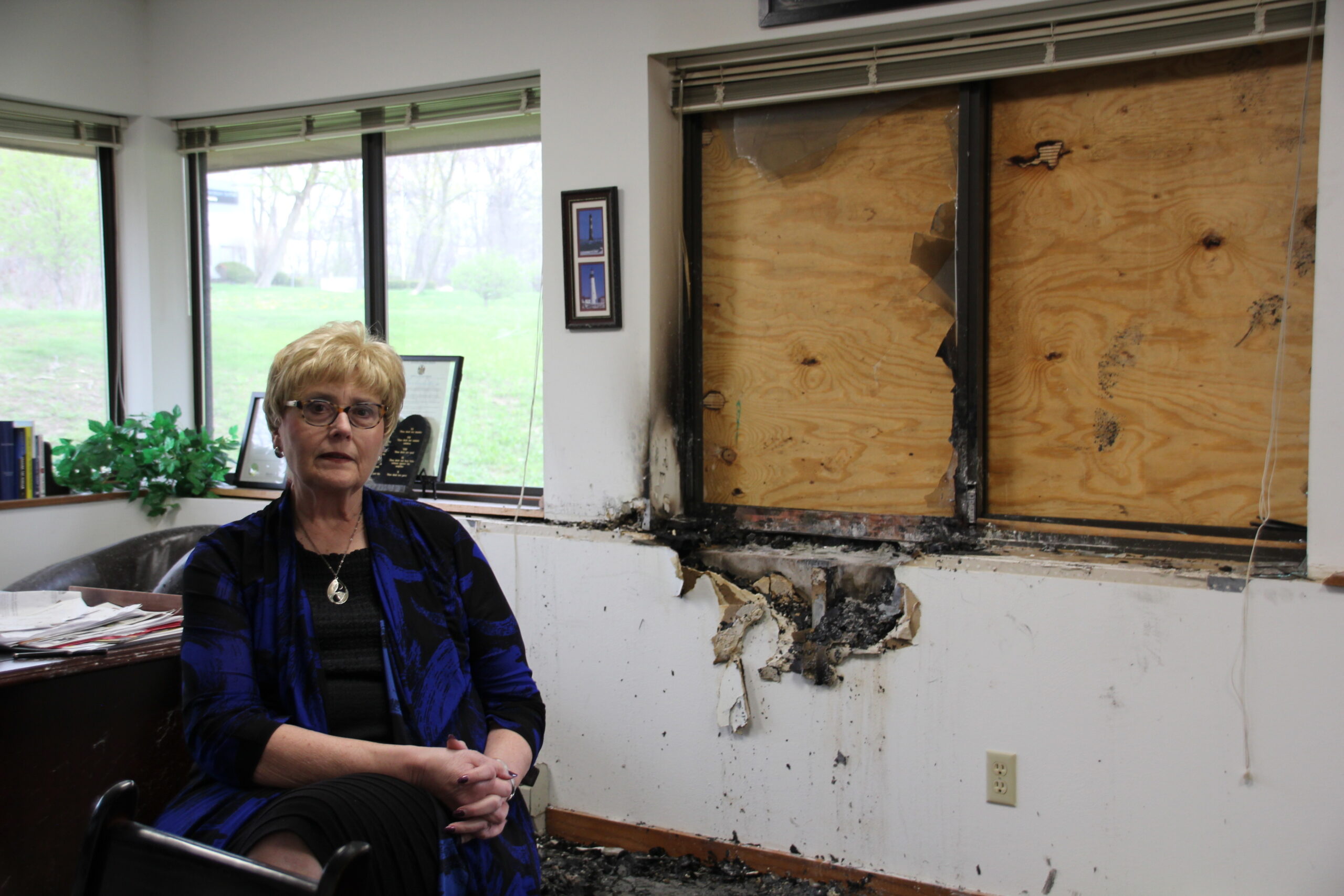 Wisconsin Family Action president Julaine Appling stands near a damaged wall of the Wisconsin Family Action offices in Madison