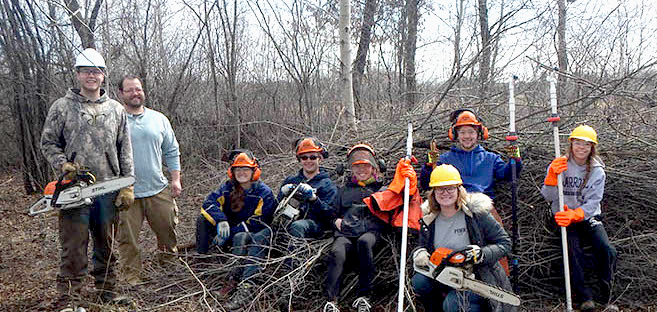 Volunteers pose for a picture after a fall day clearing brush