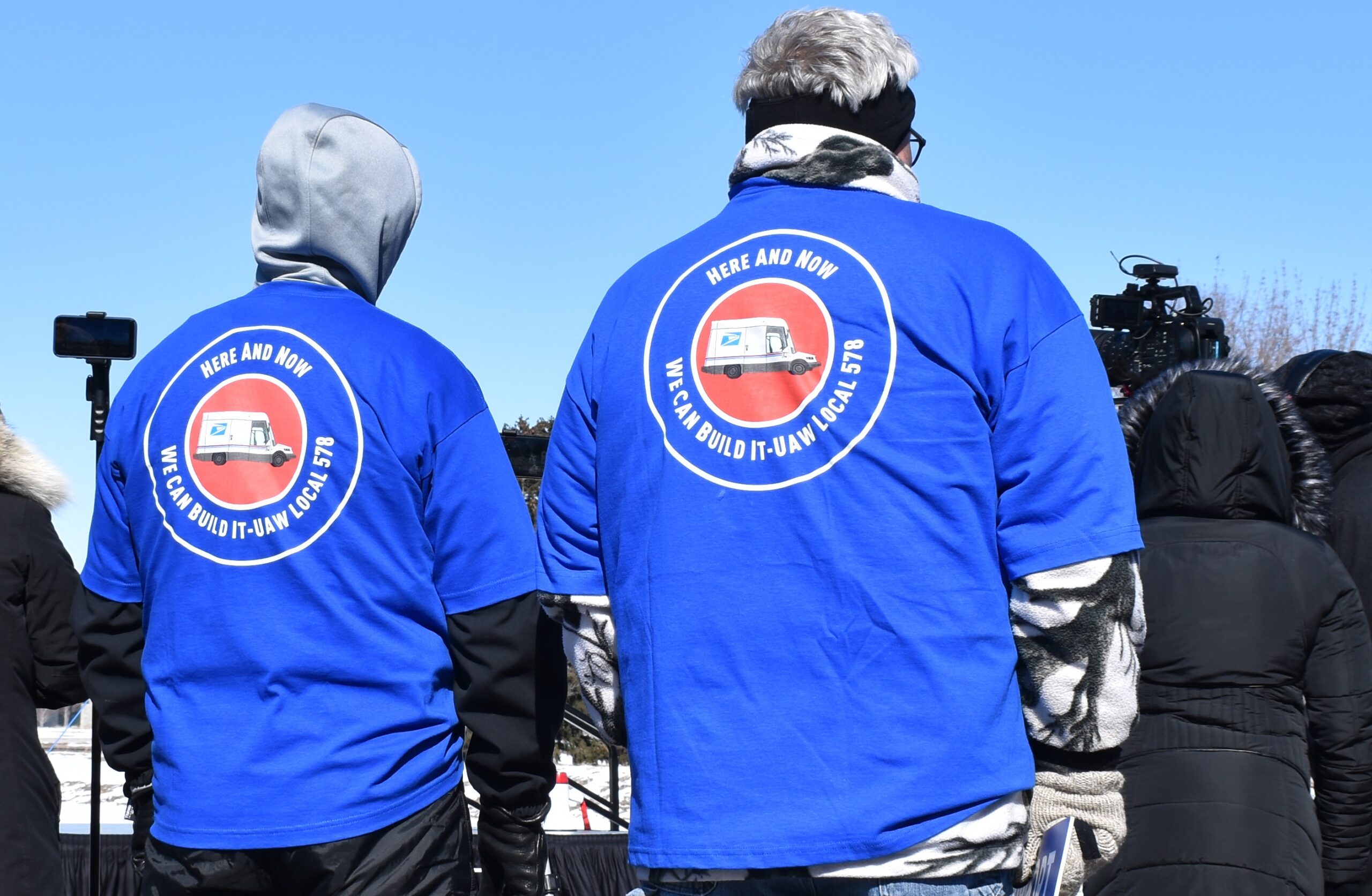 Union members' jackets call for the U.S. Postal Service's Next Generation Delivery Vehicle to be built by workers in Oshkosh