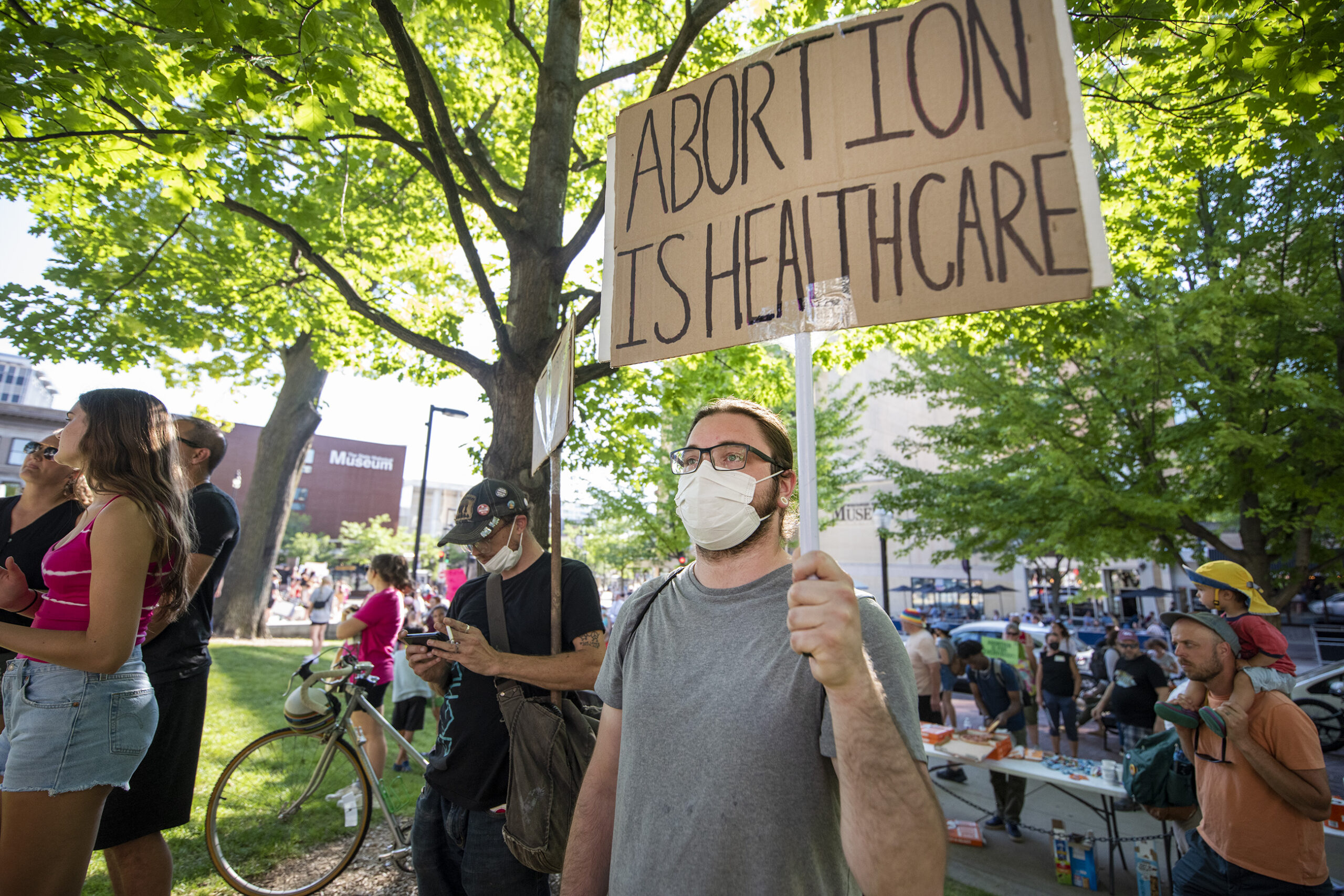 A protester's sign says 