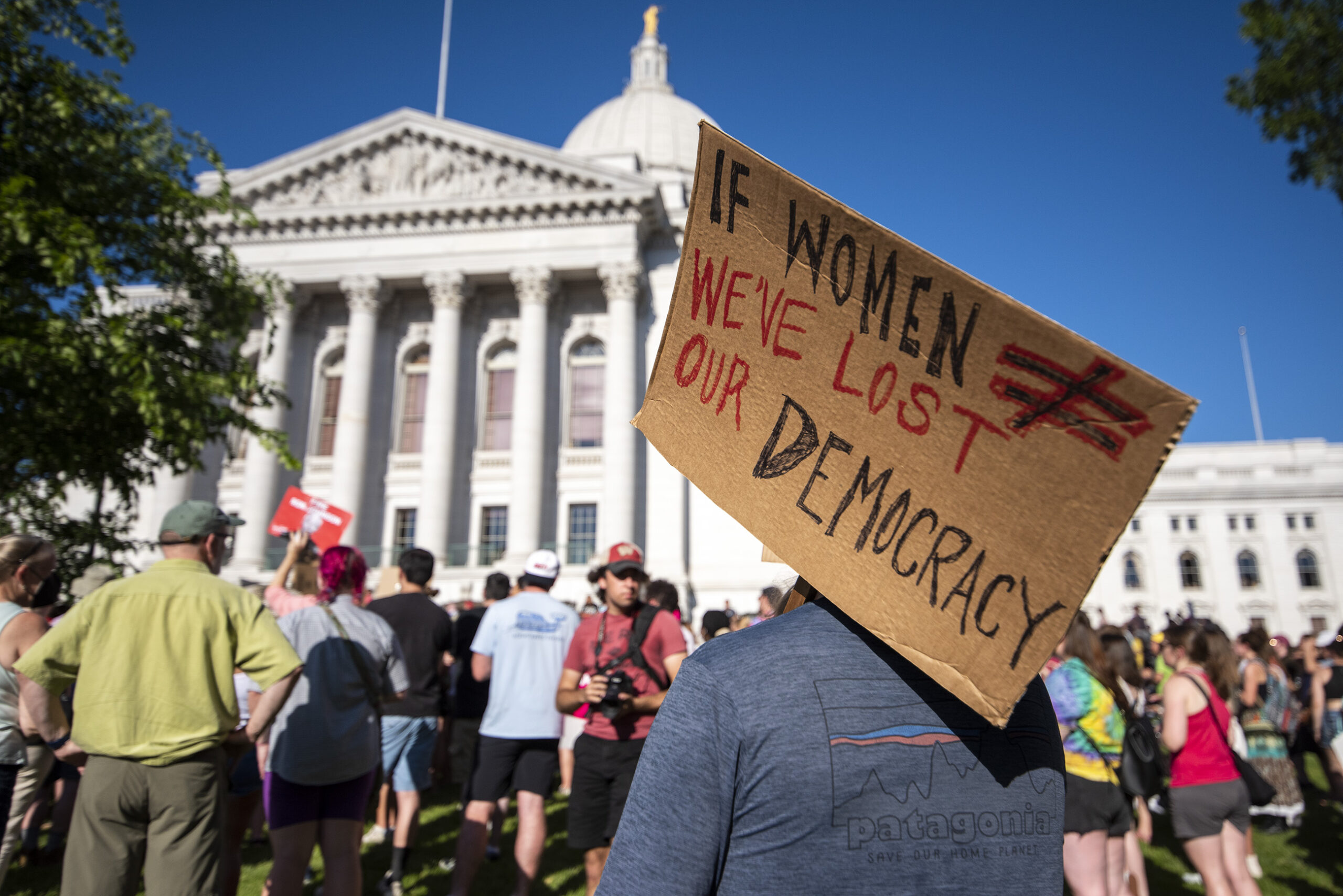 A protester's sign says 