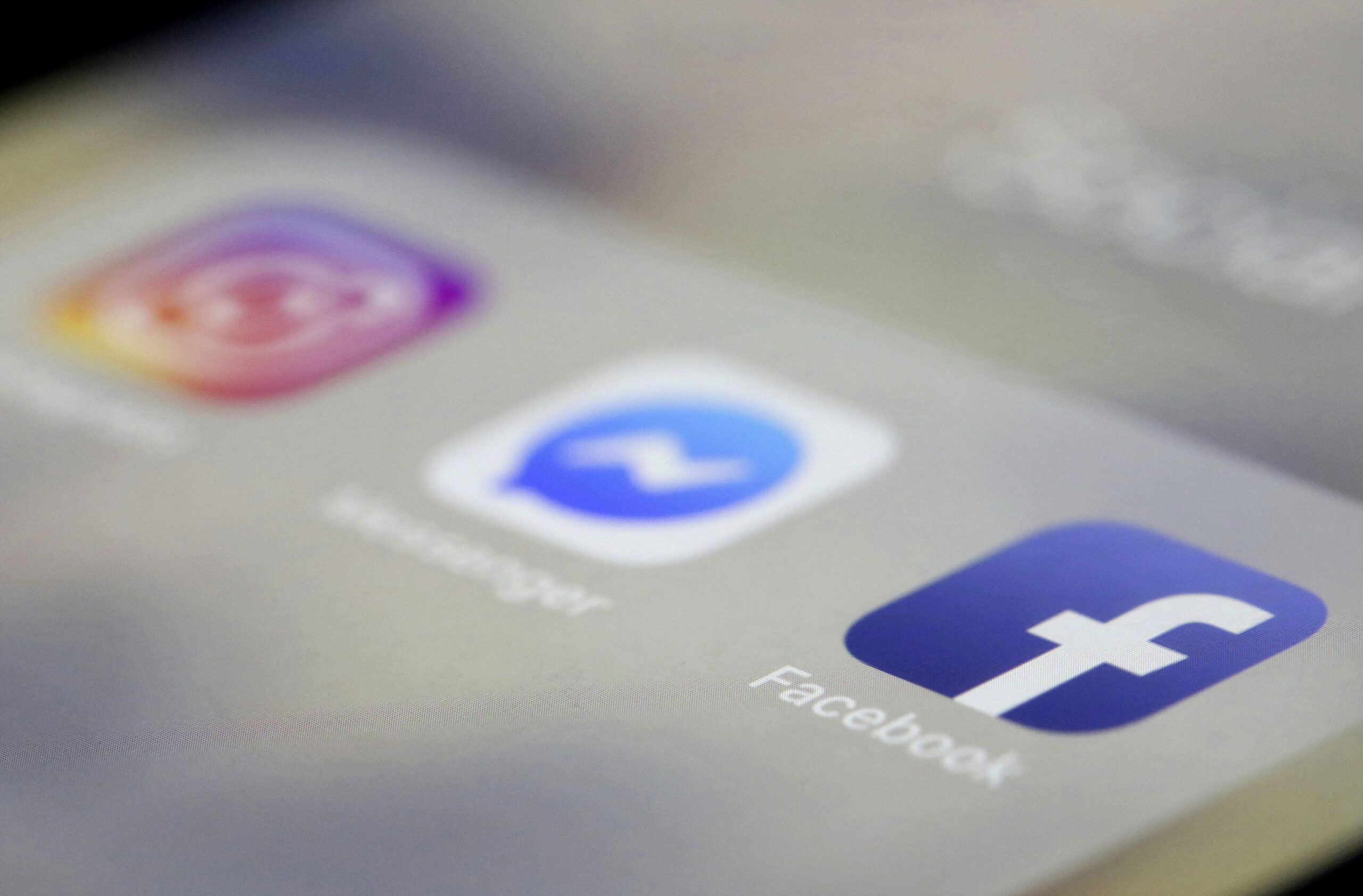 Facebook, Messenger and Instagram apps are displayed on an iPhone