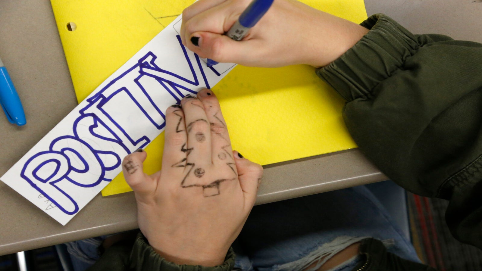 An 8th grader works on a class project.