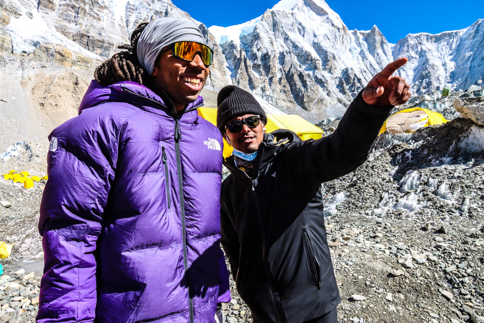 Two men talk while one is pointing while at Mount Everest's base camp
