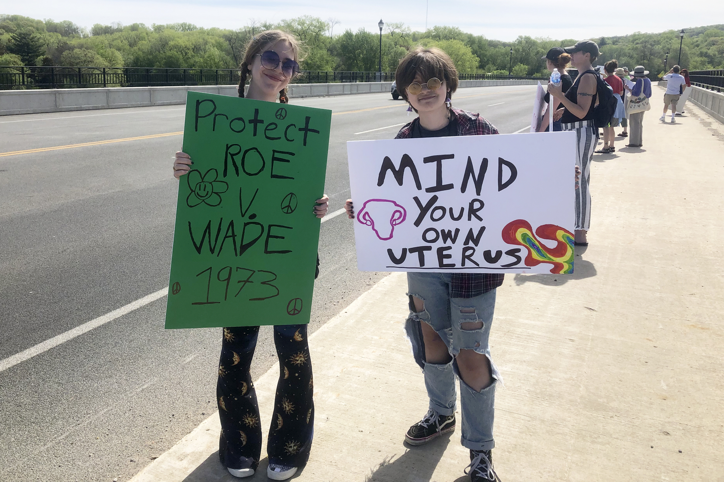 Cousins Presley Bonin, left, and Natalie Klecker, right, attend an abortion rights protest on the bridge over the Wisconsin River at Sauk City, Wis.