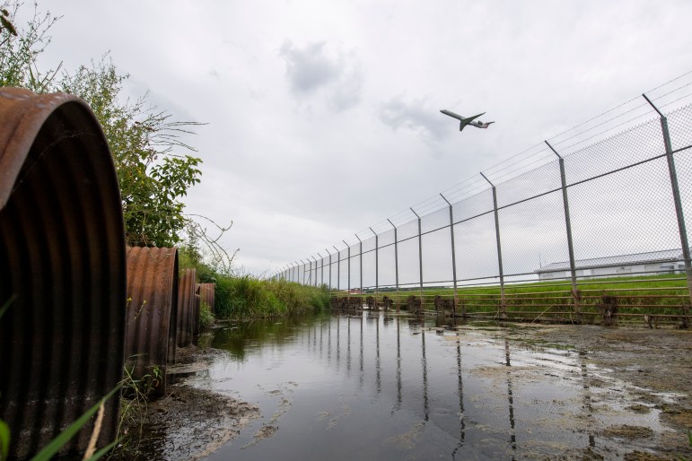 An airplane takes off near the site where Starkweather Creek exits Truax Field Air National Guard Base