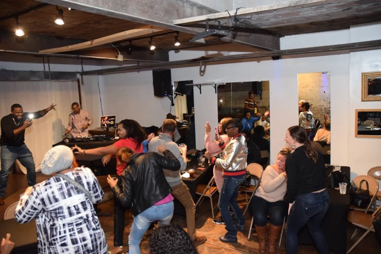 A crowd dances during a session of music-based therapy