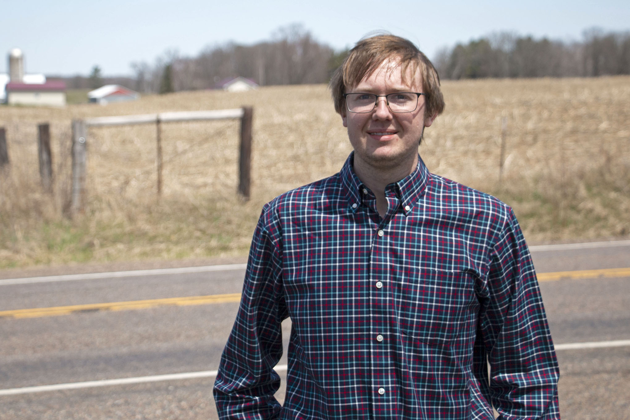 William Kunkel stands in front of a farm in Jim Falls, Wisconsin